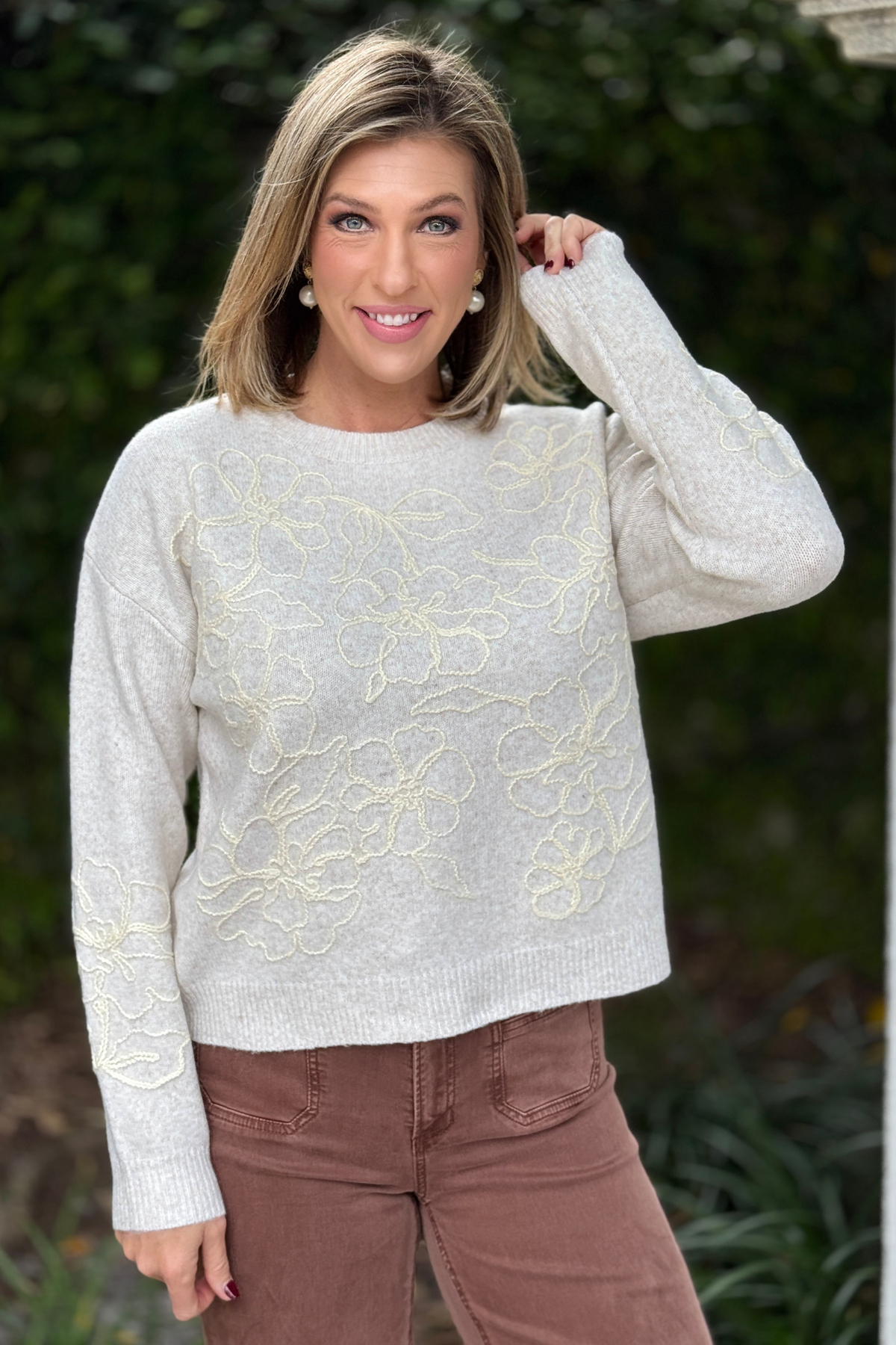 Oatmeal floral embroidered sweater styled with brown pants