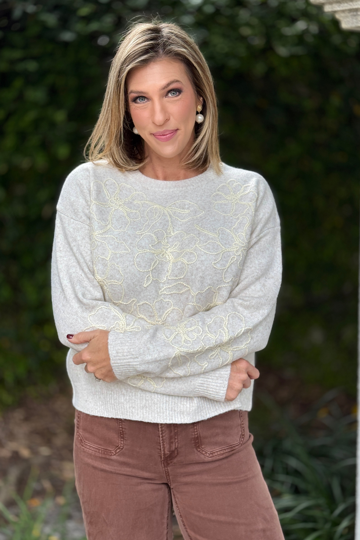 Women’s oatmeal sweater with floral embroidery across front