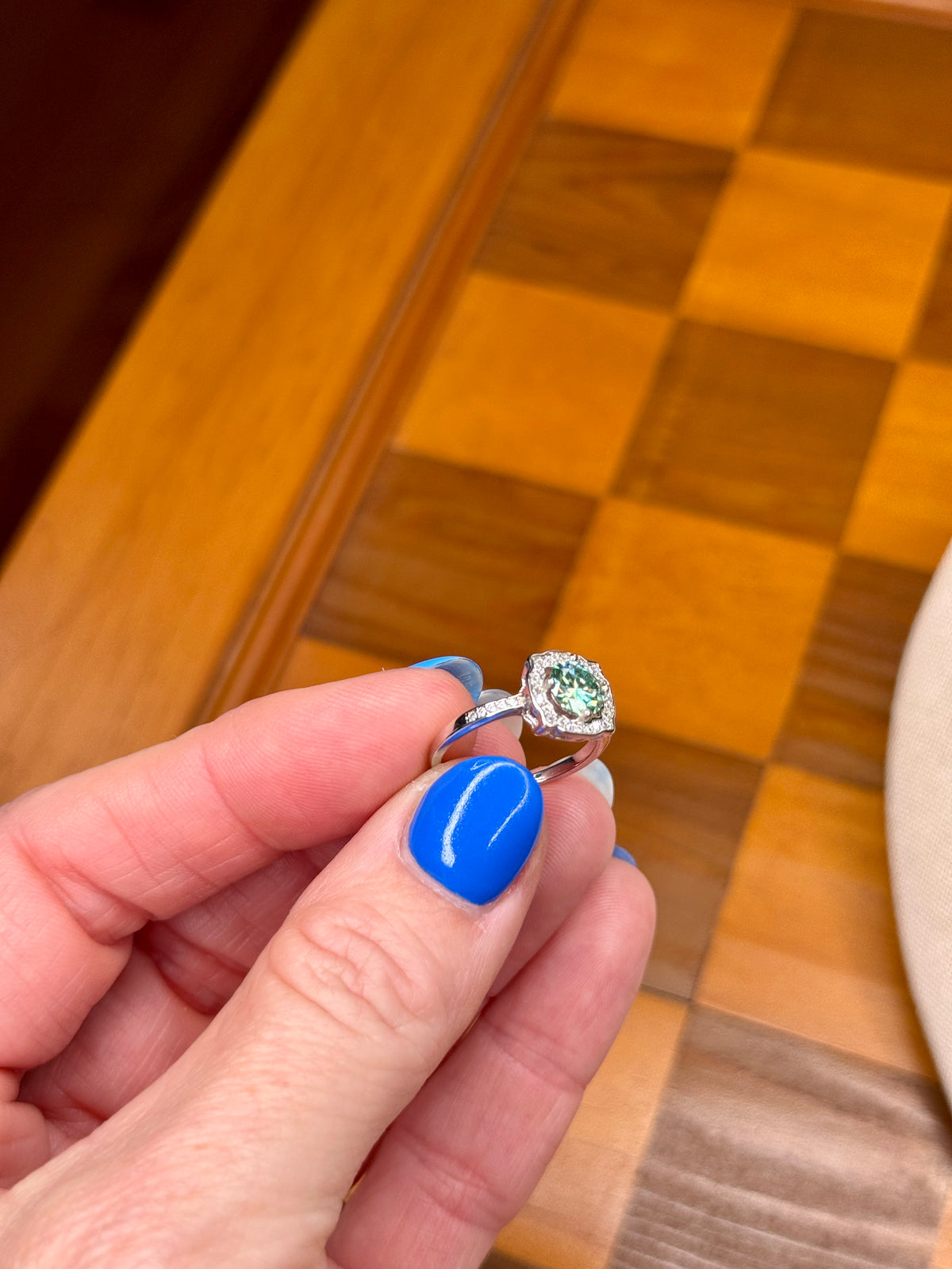 close up of oval moissanite ring with pavé band