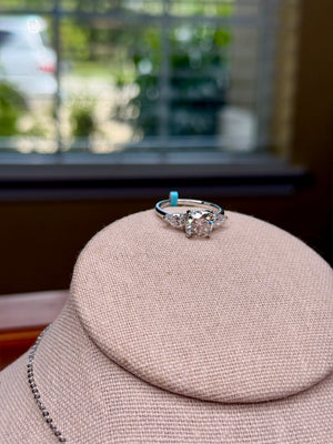 large moissanite engagement style ring with side stones