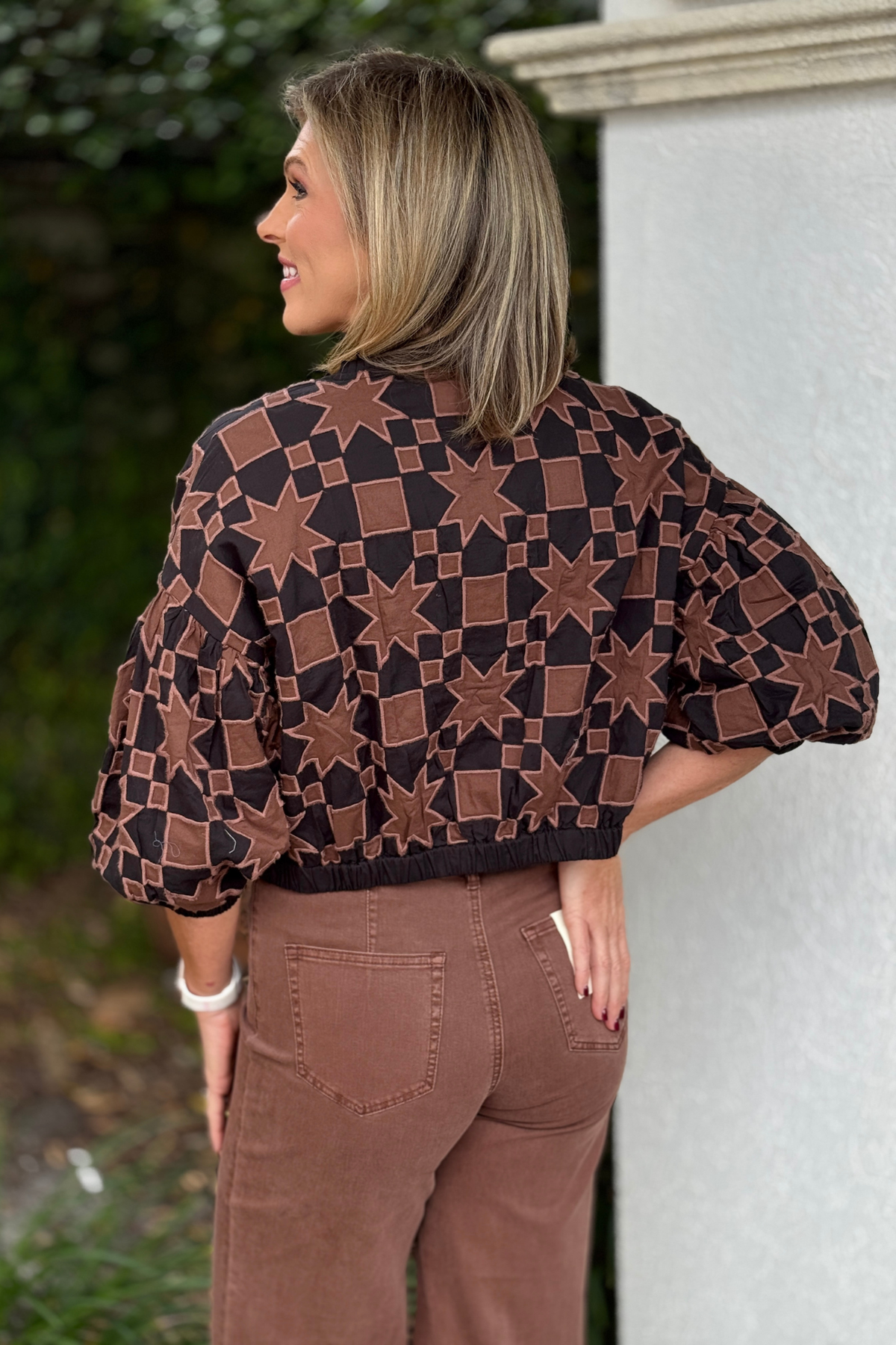 Brown and black quilted jacket styled with chocolate pants