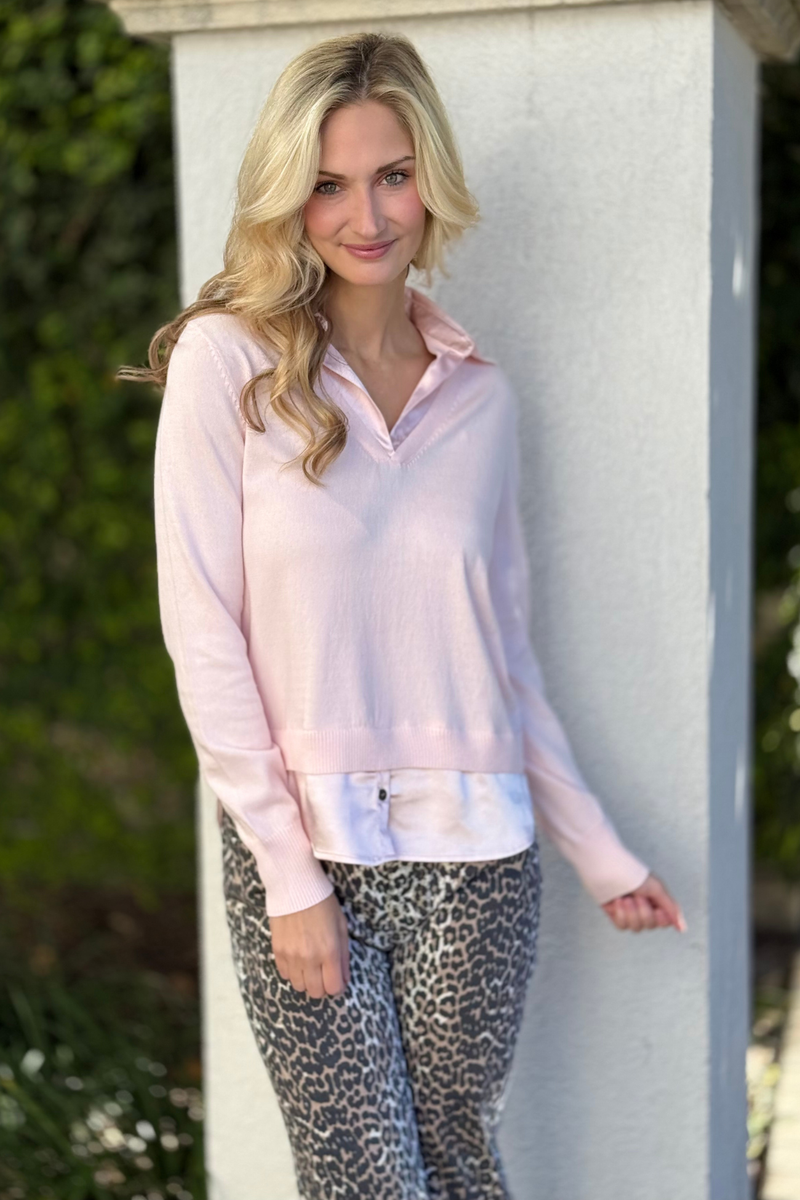 Close-up of blush v-neck layered sweater with collar detail