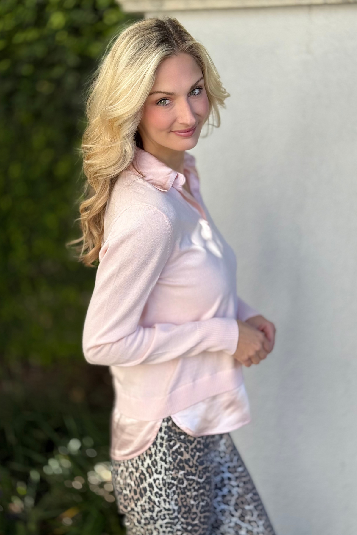 Side view of J. Society blush sweater showing layered hem