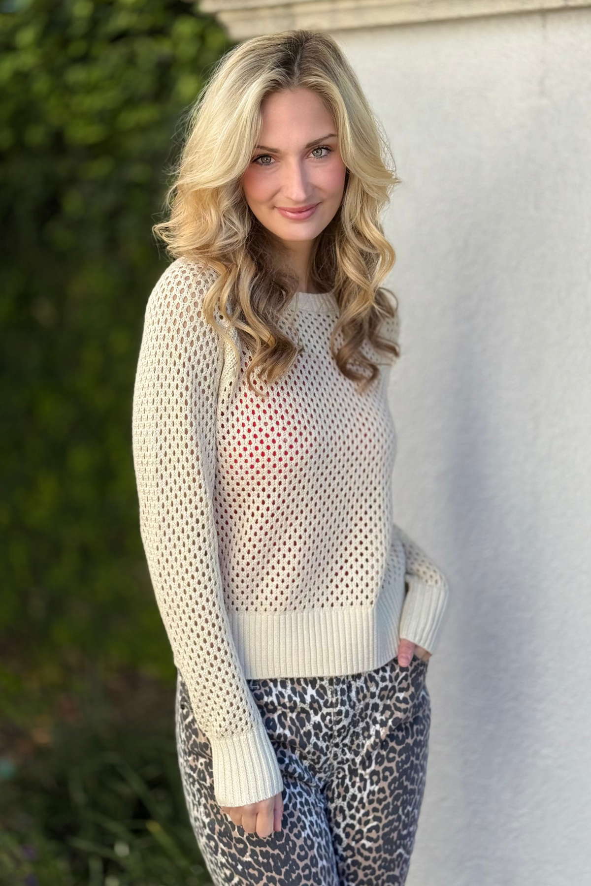 Close-up of cream open weave sweater with metallic shimmer