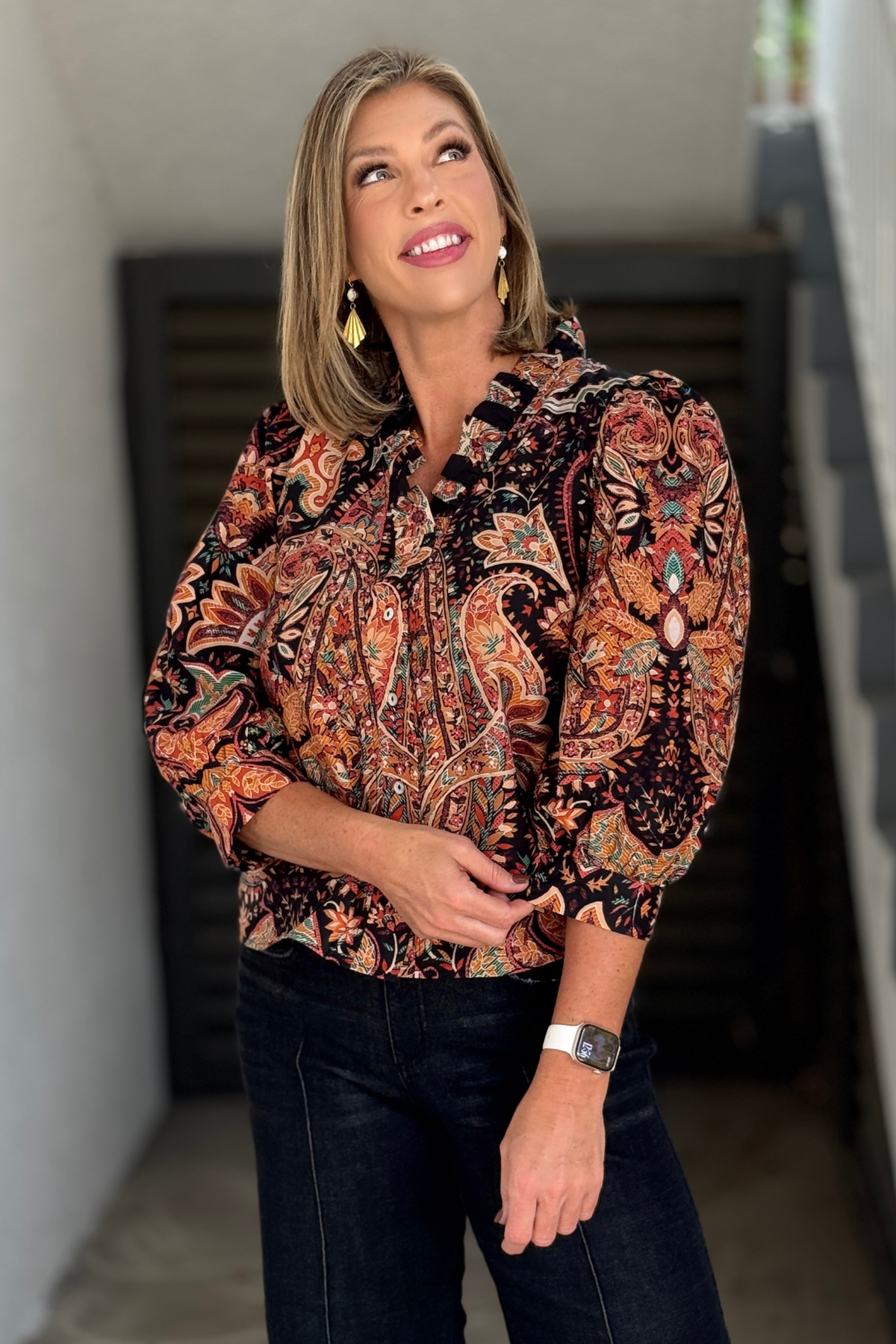 Women's transitional fall floral blouse styled with dark denim
