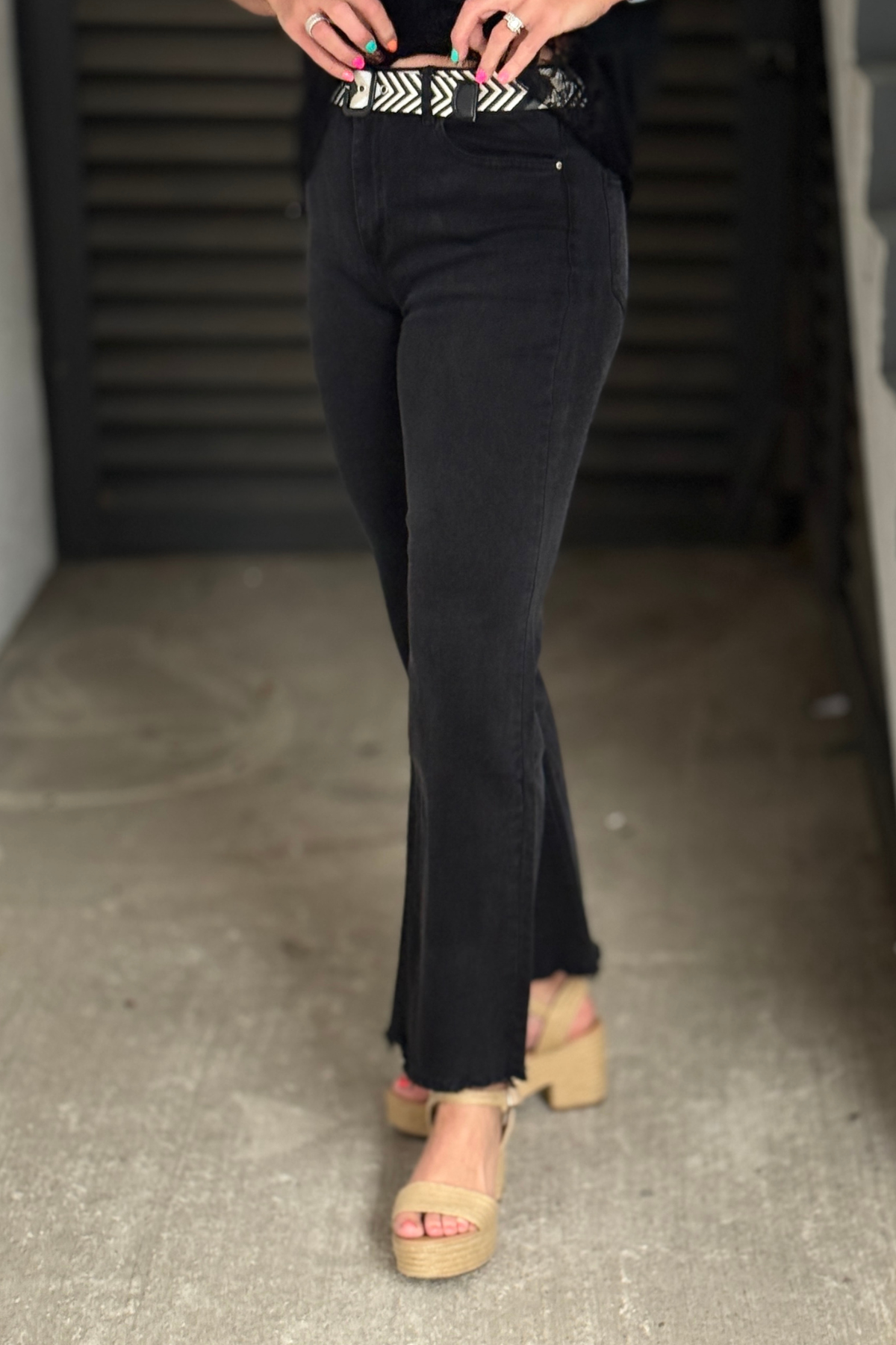 Stretch black wide leg denim with raw hem