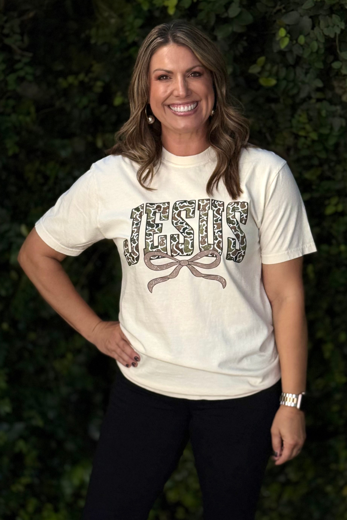 Women’s Christian graphic tee with camo JESUS lettering and bow detail