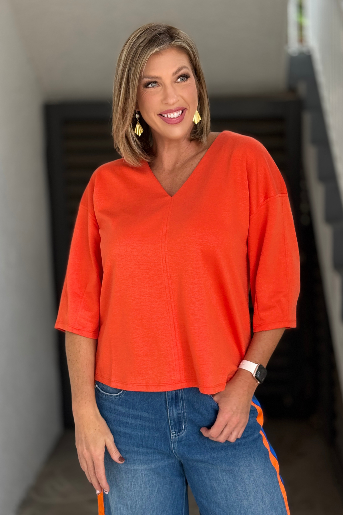 Lightweight orange V-neck top with center seam detail