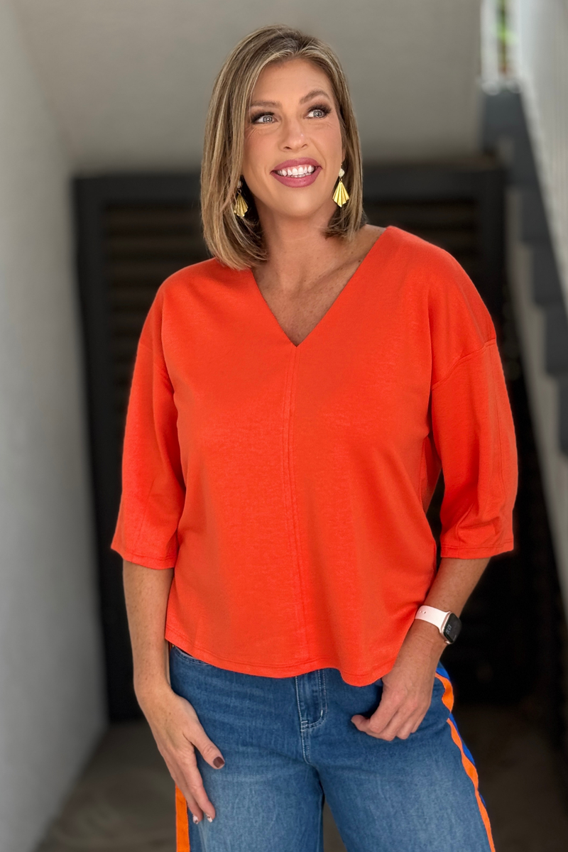 Women's relaxed orange V-neck top with 3/4 sleeves