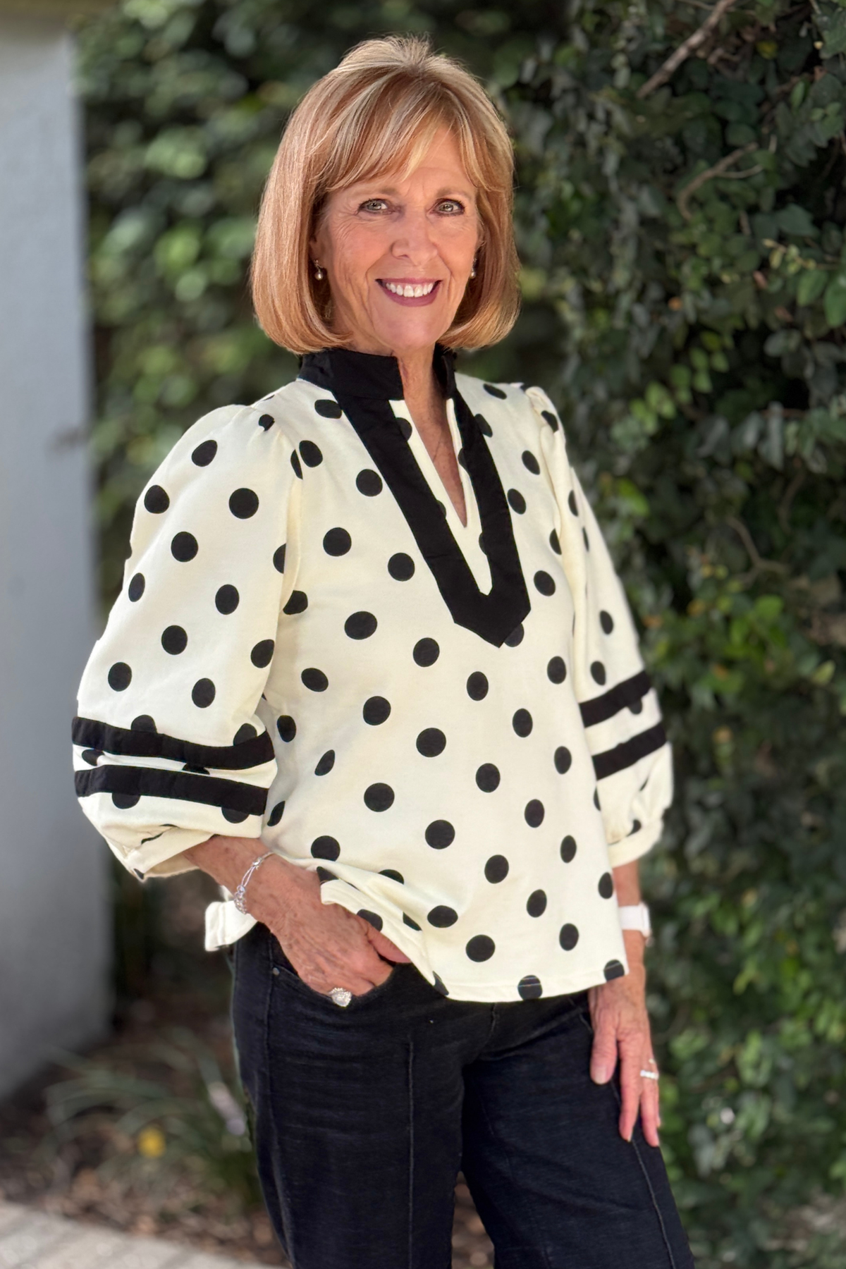 Black and cream notched V-neck polka dot blouse