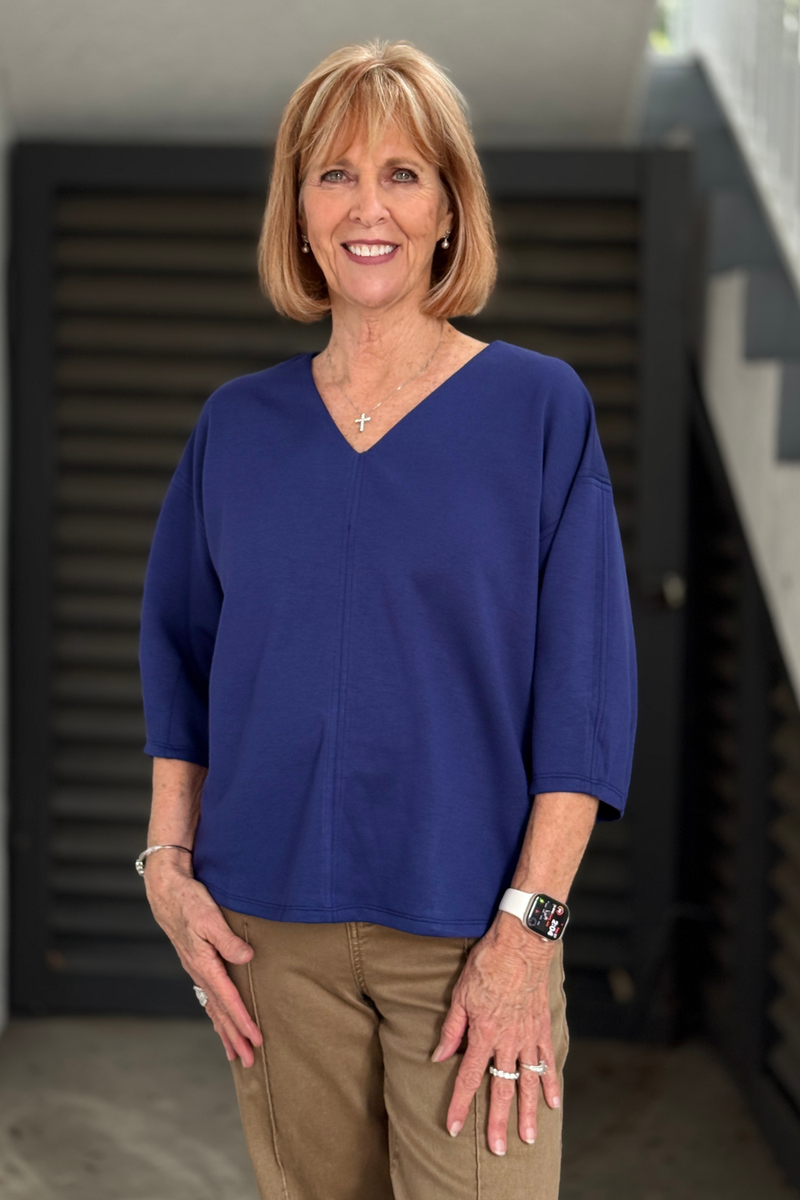 Women's navy V-neck top with relaxed boxy fit