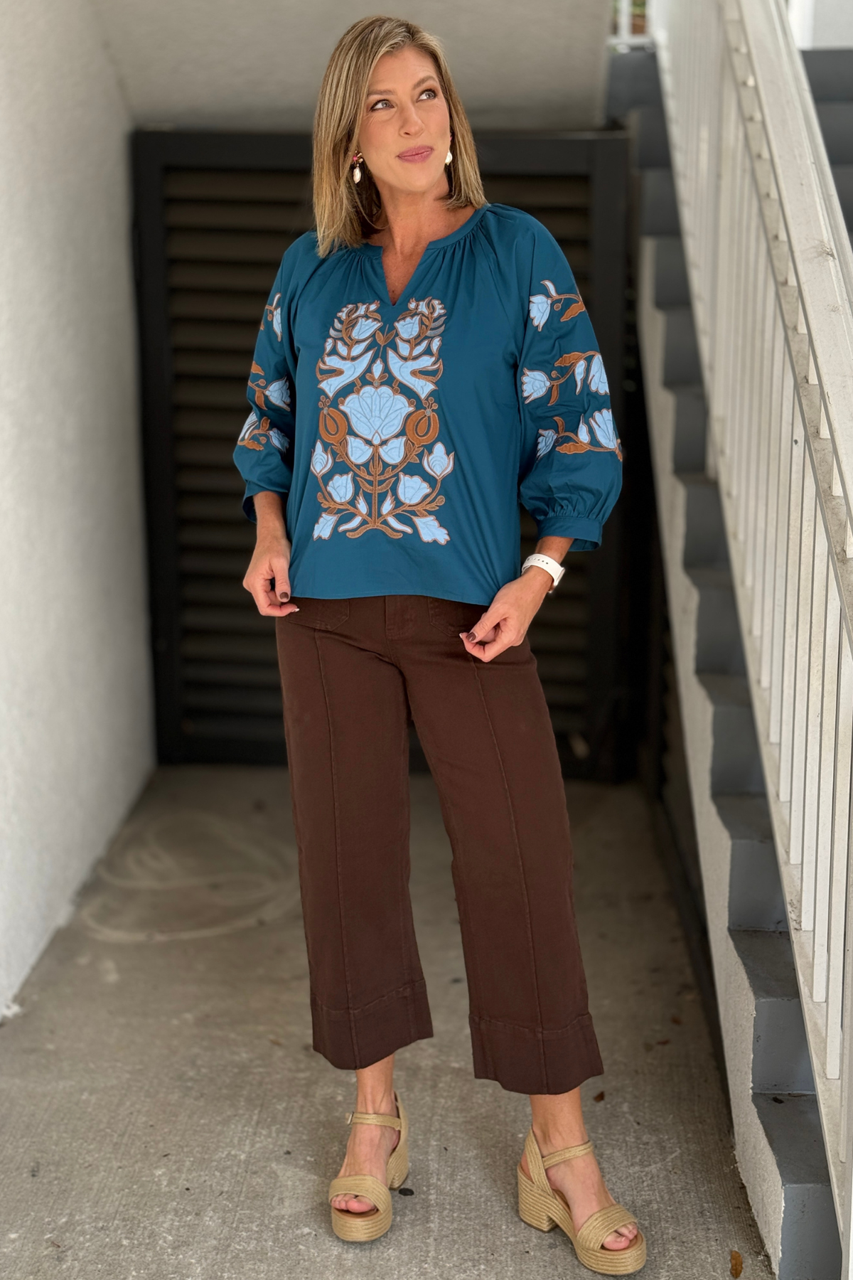 Ornate floral embroidered top in teal with blue and brown detailing