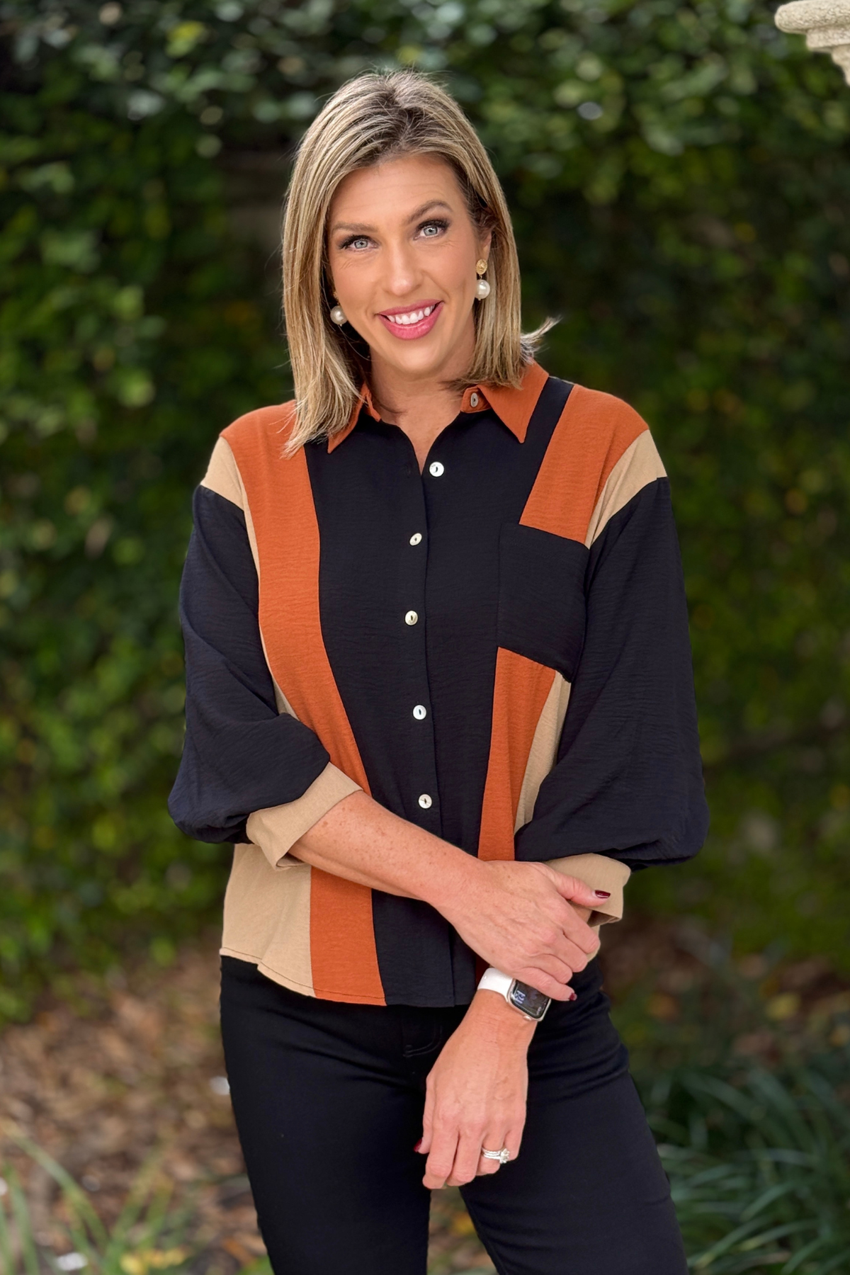 Relaxed colorblock blouse styled with black pants
