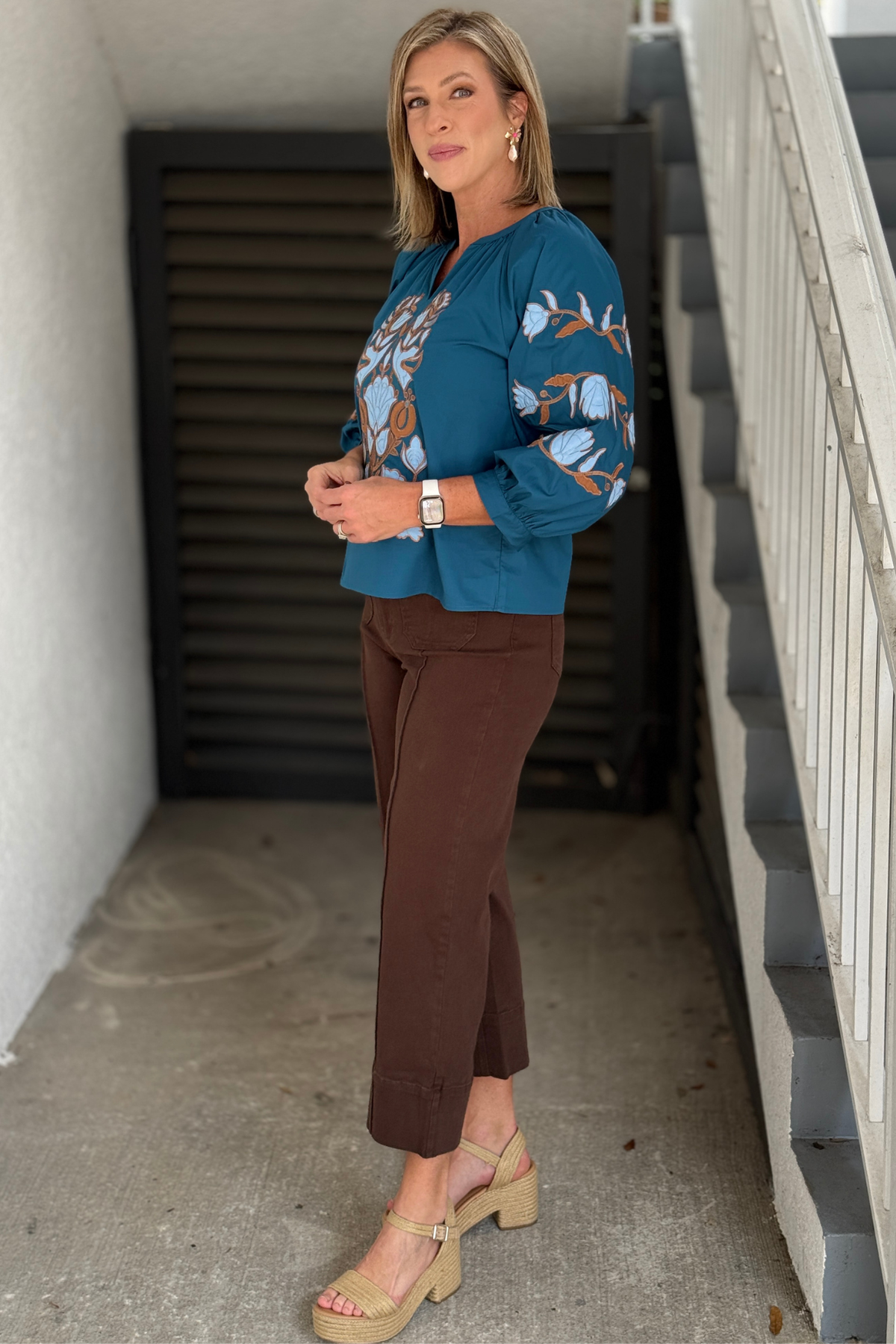 Teal floral appliqué top with three-quarter sleeves