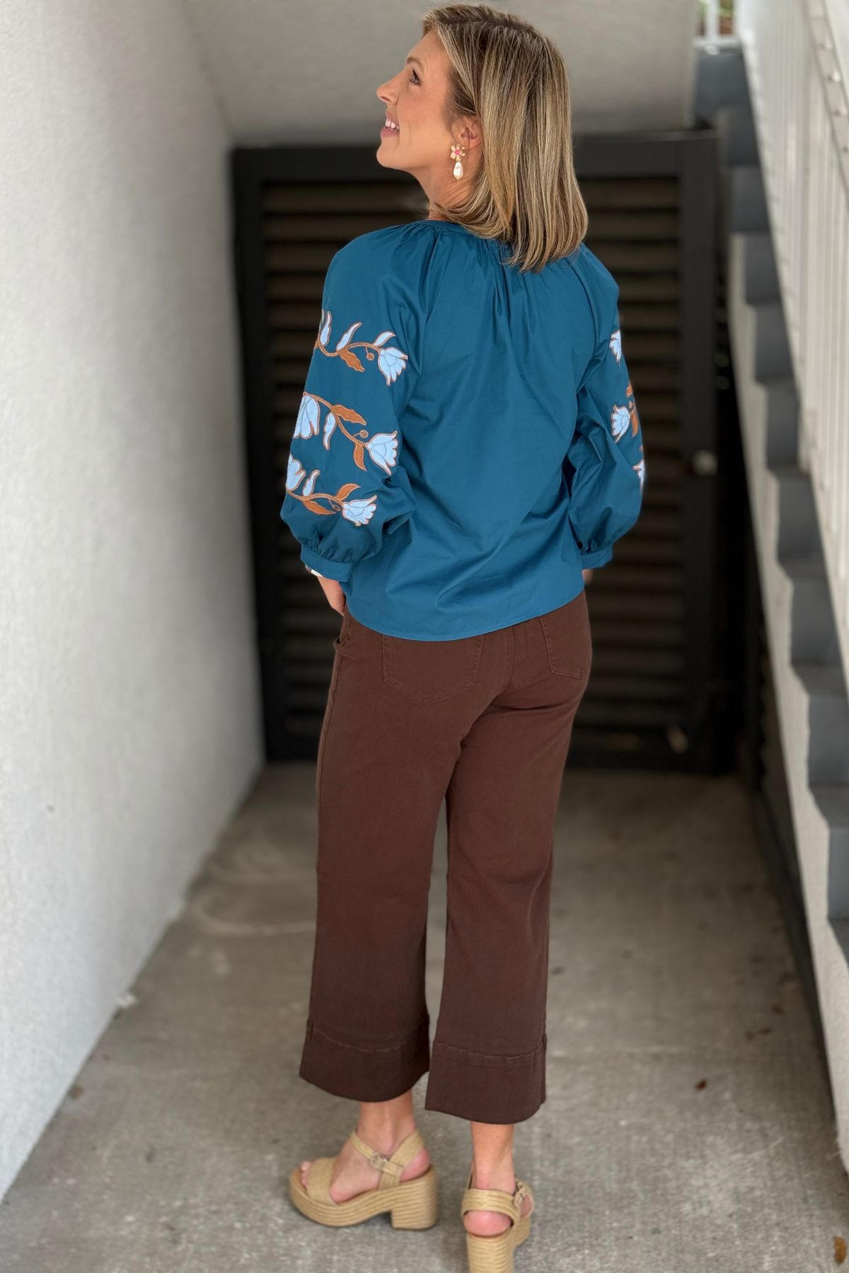 Boutique teal blouse with floral embroidery on front and sleeves