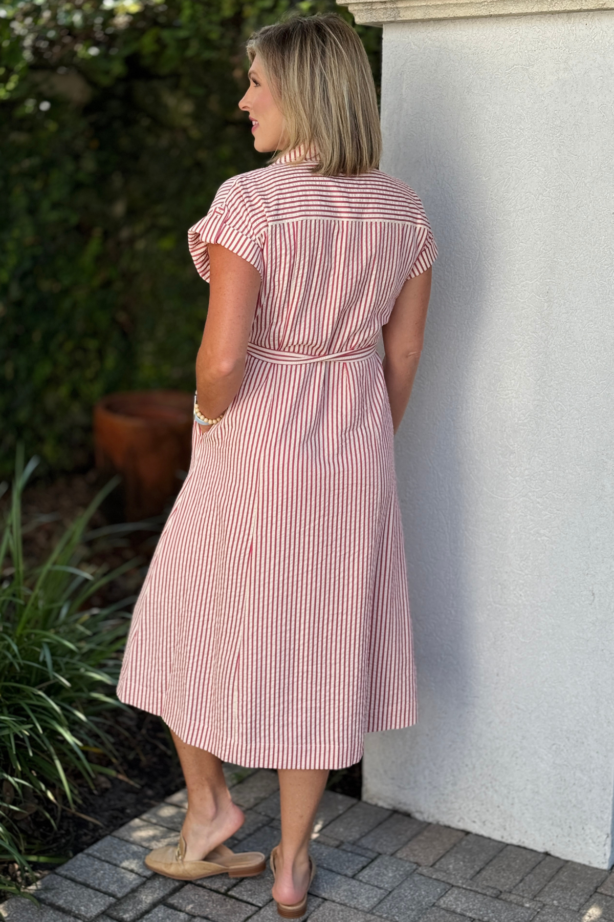 Back view of red stripe midi dress with waist tie