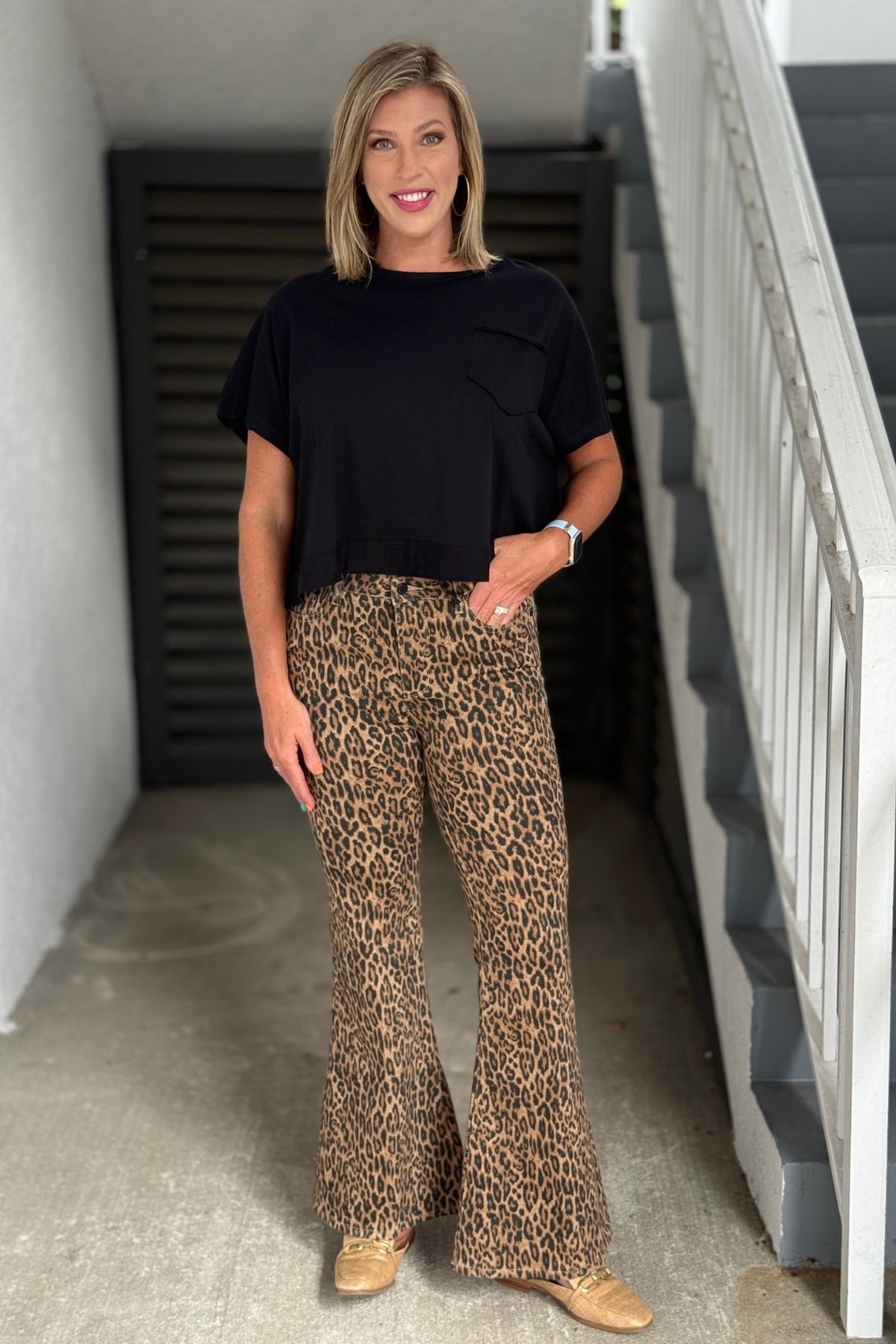 Leopard Luxe Jaqueline flare jeans styled with a black top.