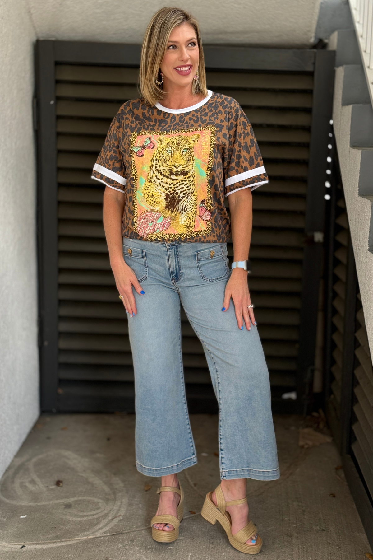 Back view of wide leg light wash jeans with cropped hem