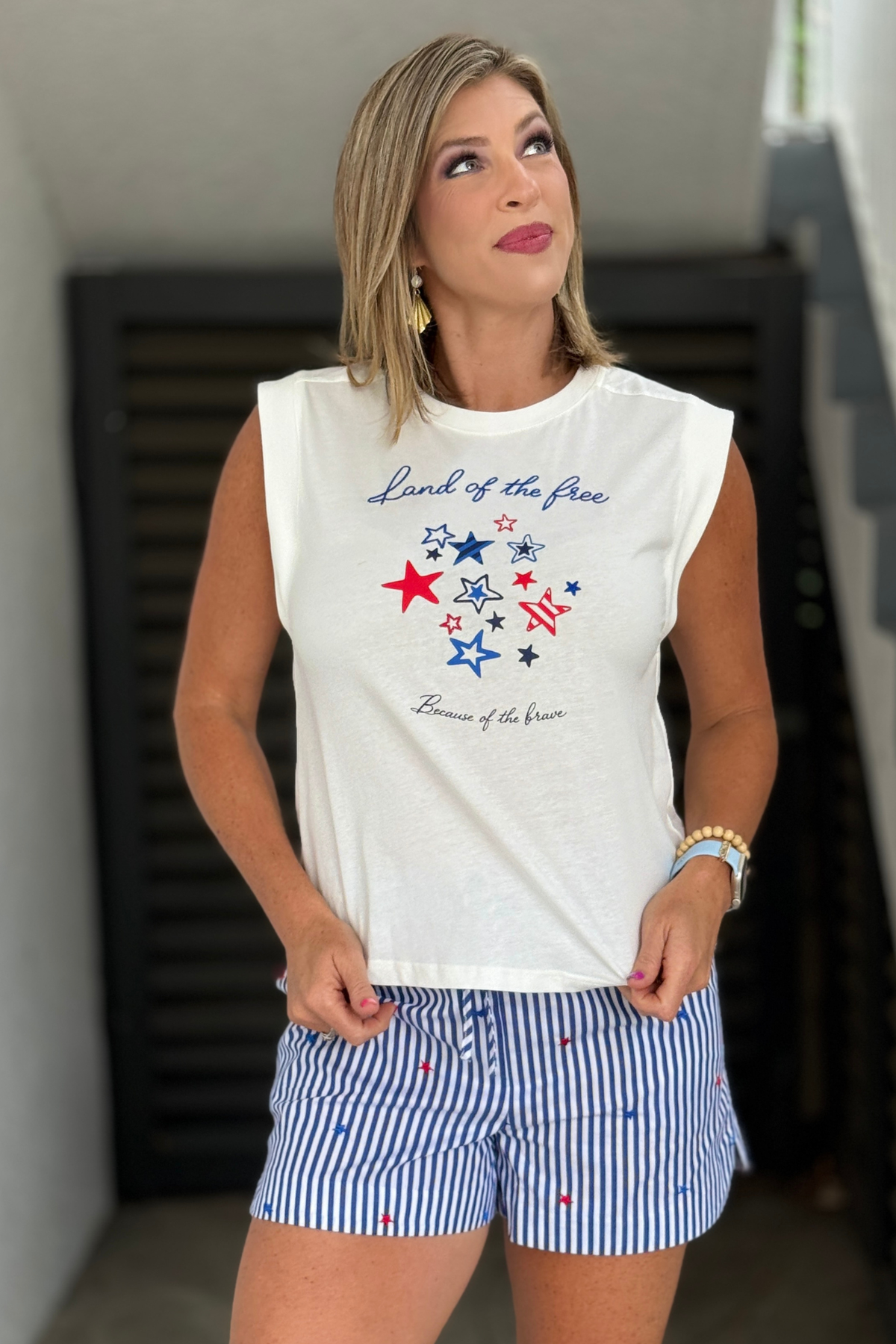 White sleeveless graphic tee with patriotic star design