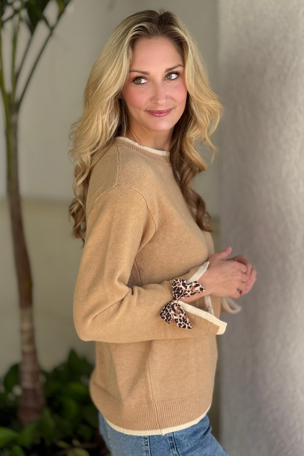 Boutique leopard bow sweater styled with denim jeans