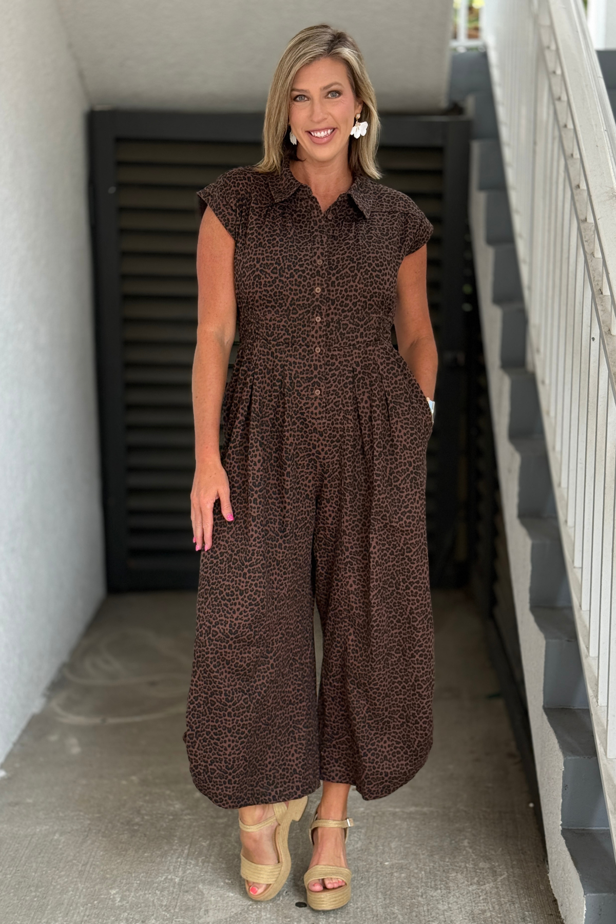 Leopard print jumpsuit styled with neutral platform sandals.