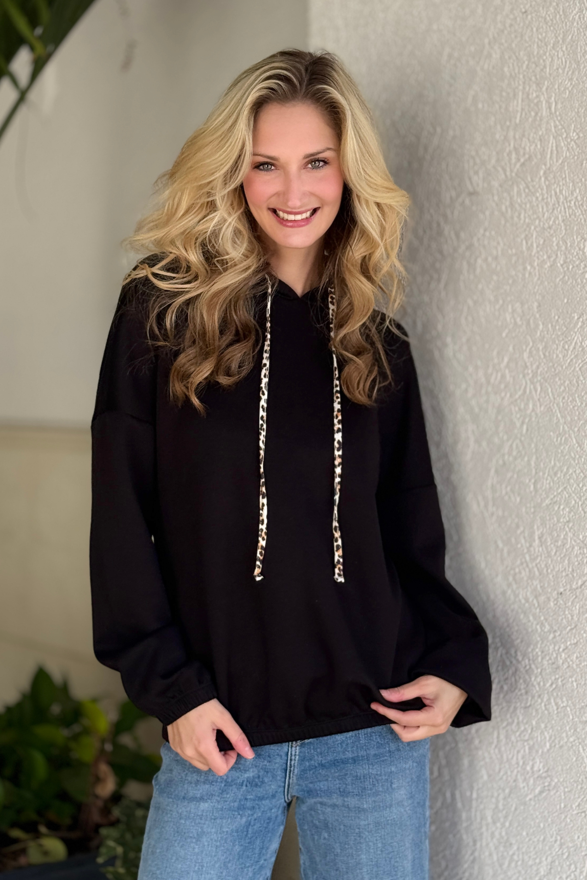 Black hooded sweatshirt with leopard drawstring detail