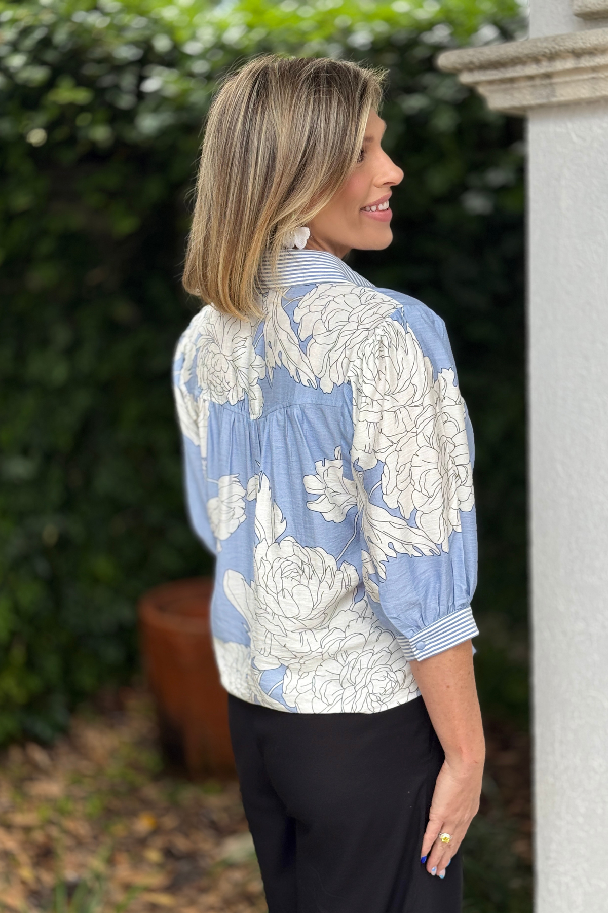 Back view of misty blue floral blouse with soft drape