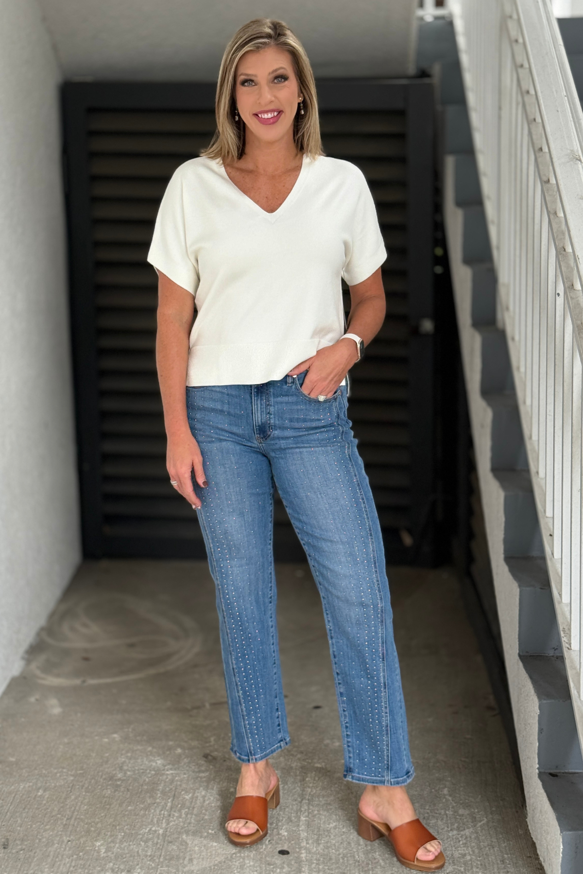 Women’s medium wash straight leg jeans with subtle studs