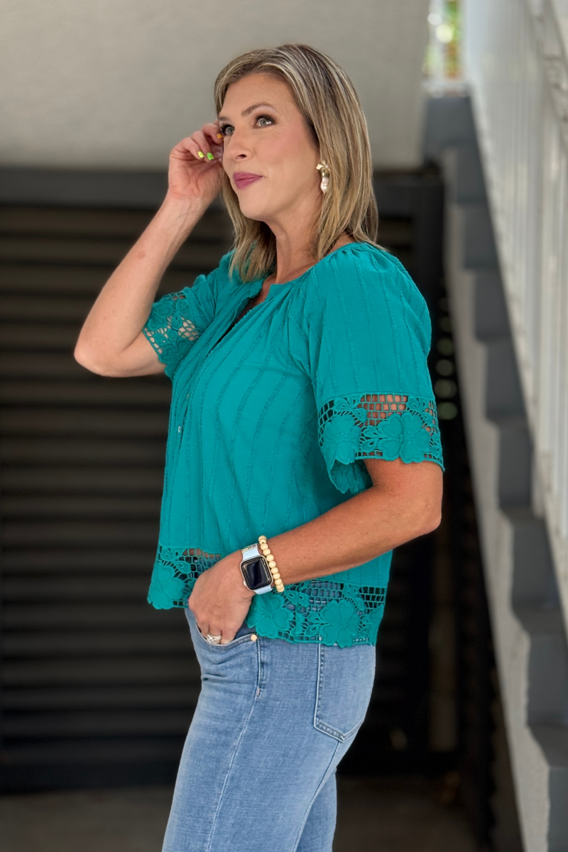 Teal cotton blouse with embroidered lace hem