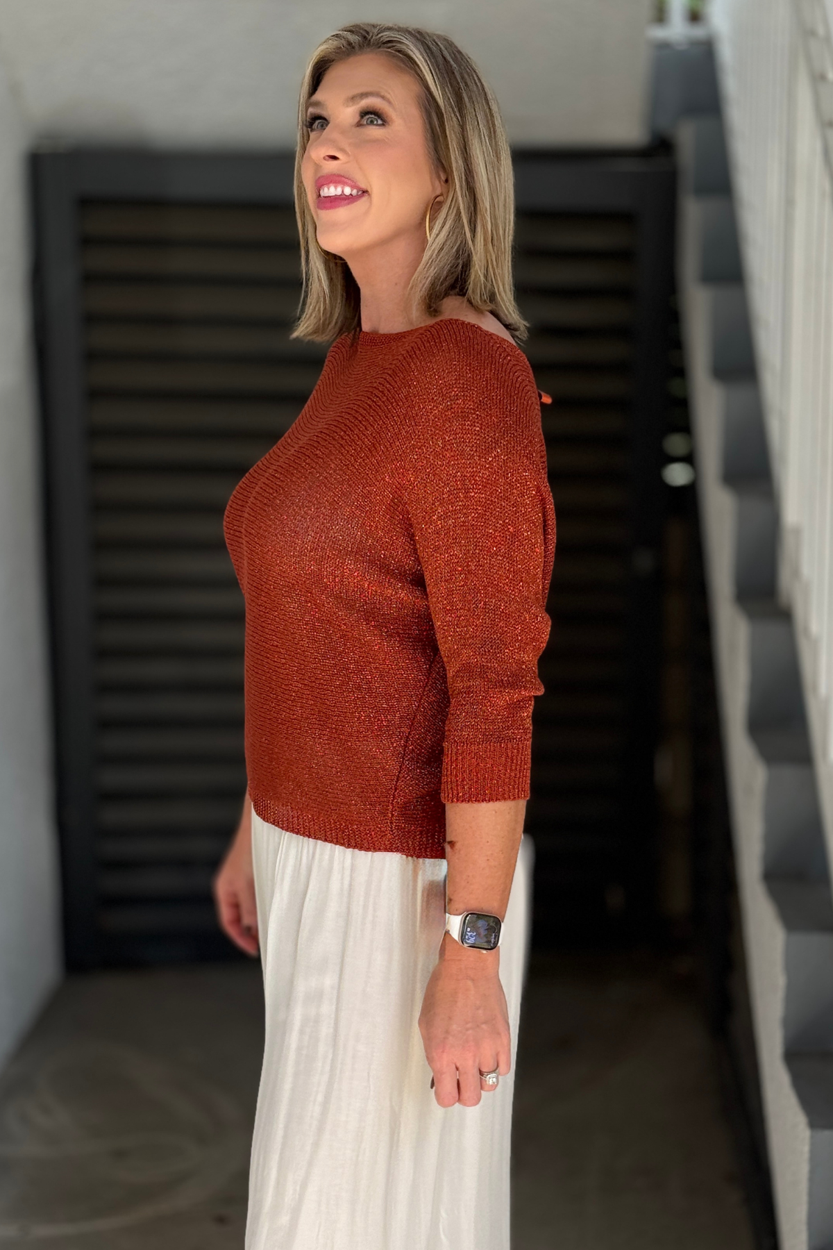 Back view of shimmer sweater with keyhole opening and satin bow