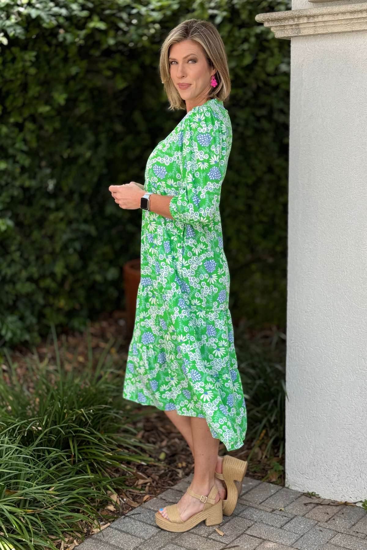 flowy green floral dress styled for spring and summer