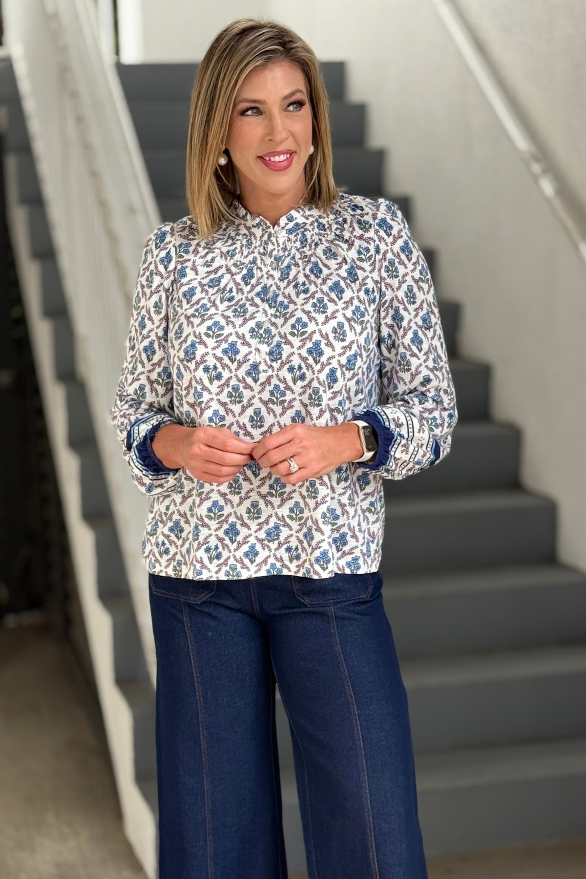 Women's ivory and blue floral blouse with ruffle neckline