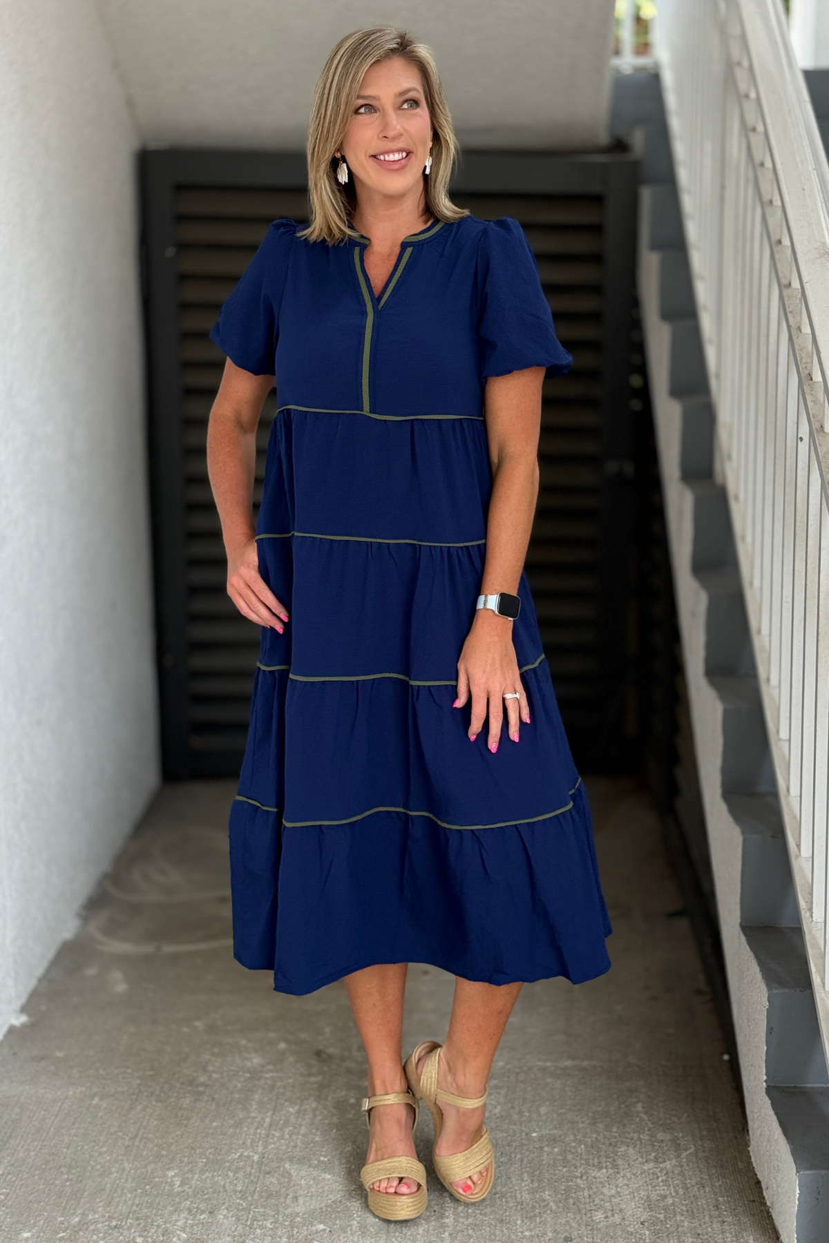 Side view of navy bubble sleeve dress with pockets