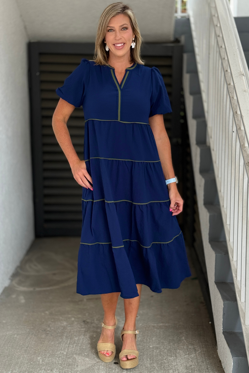 Front view of navy seersucker tiered midi dress