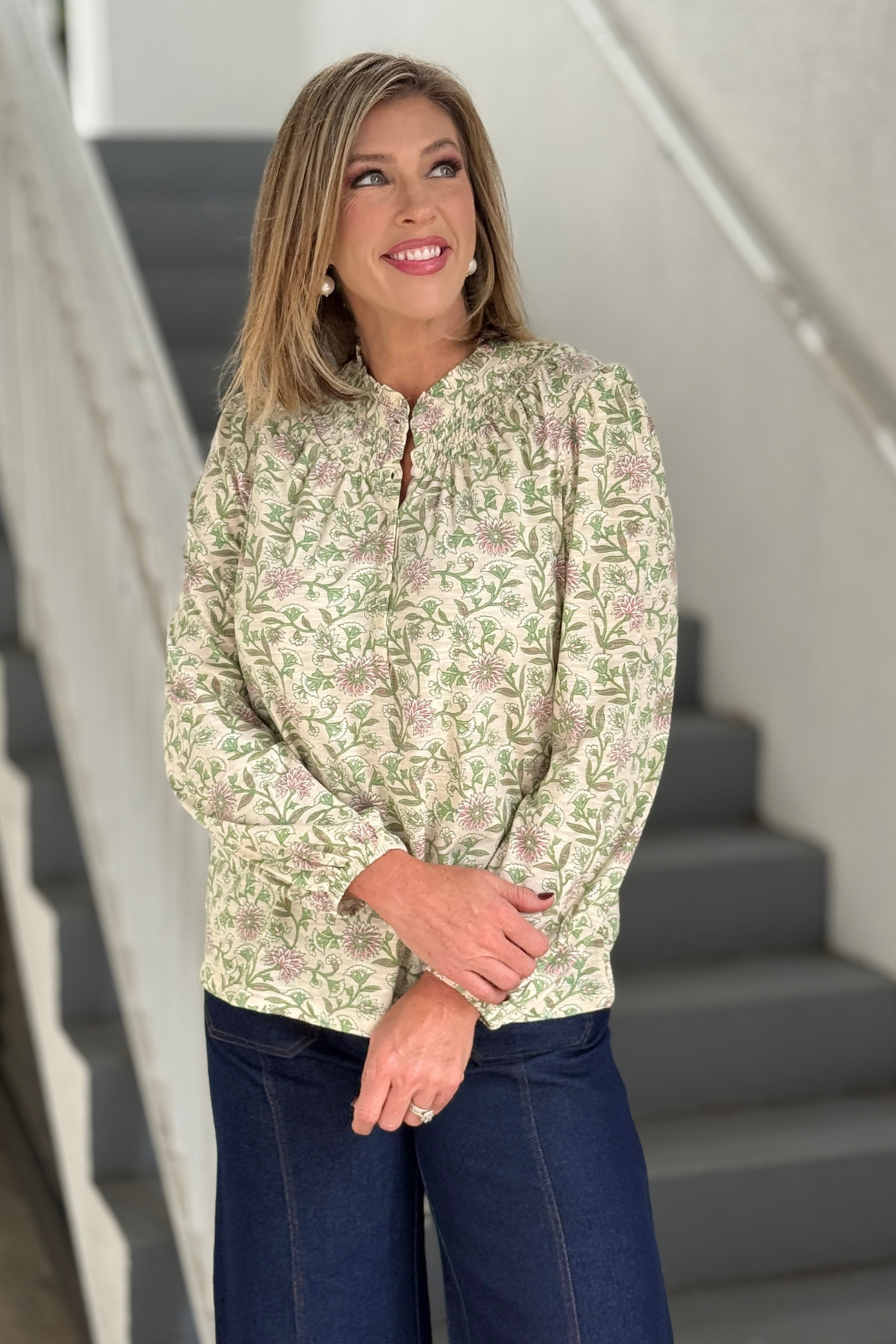 Women's tan floral long sleeve top styled with dark denim