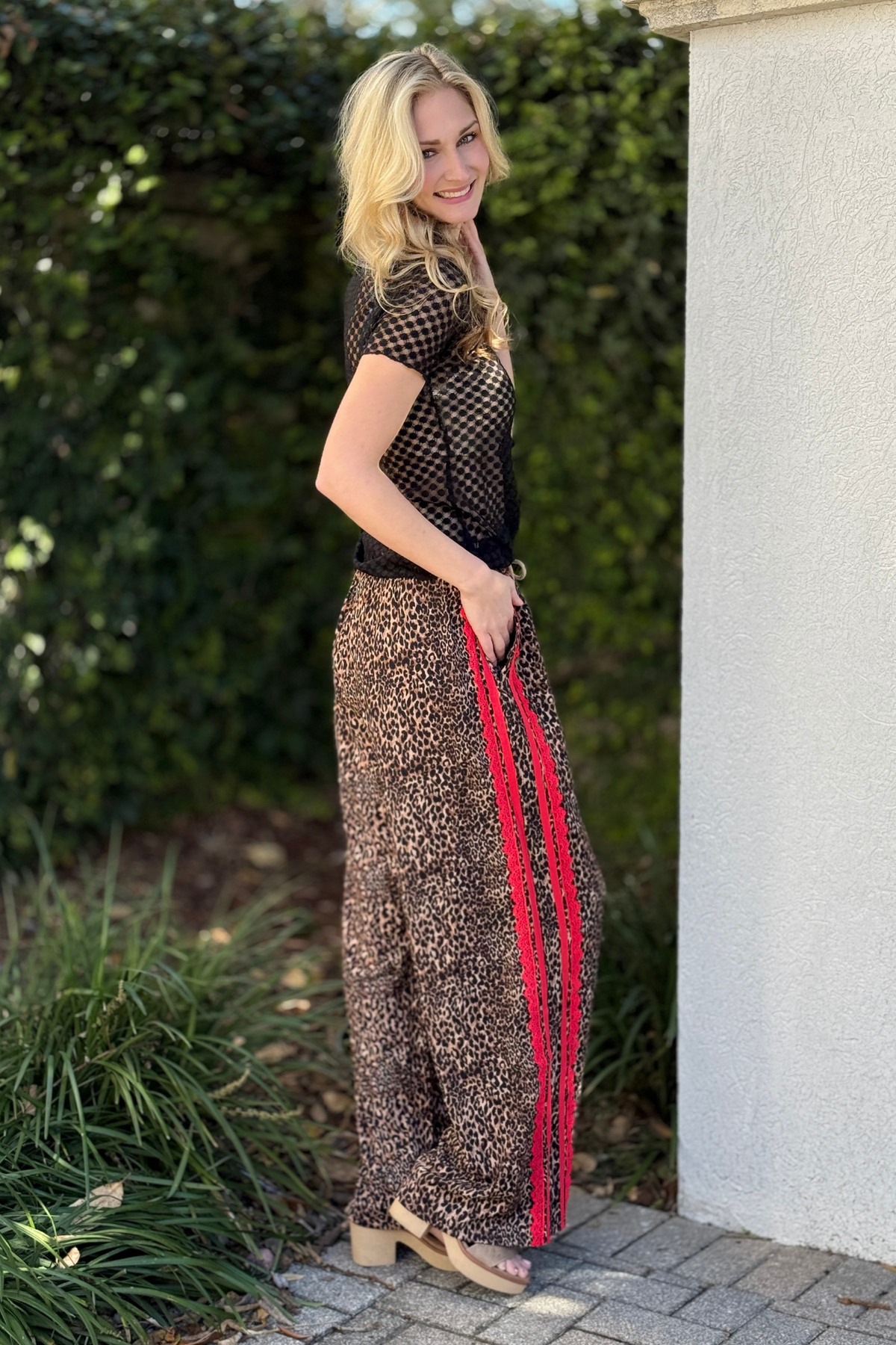 Back view of wide leg leopard pants with lace trim