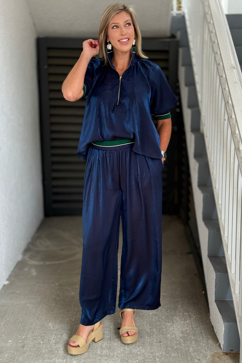 Navy satin wide leg pants with emerald contrast waistband