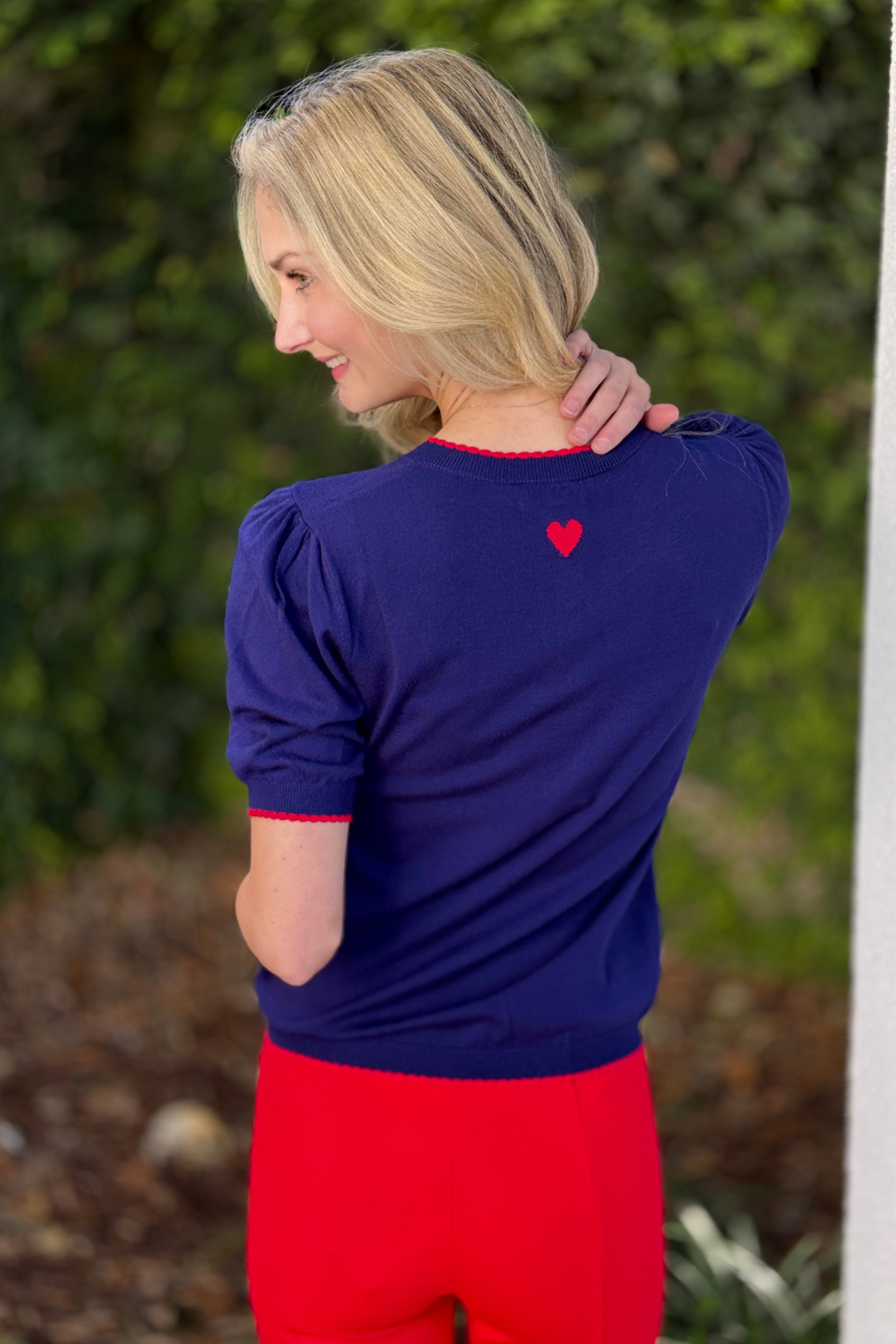 Boutique navy short sleeve knit sweater with feminine trim detail