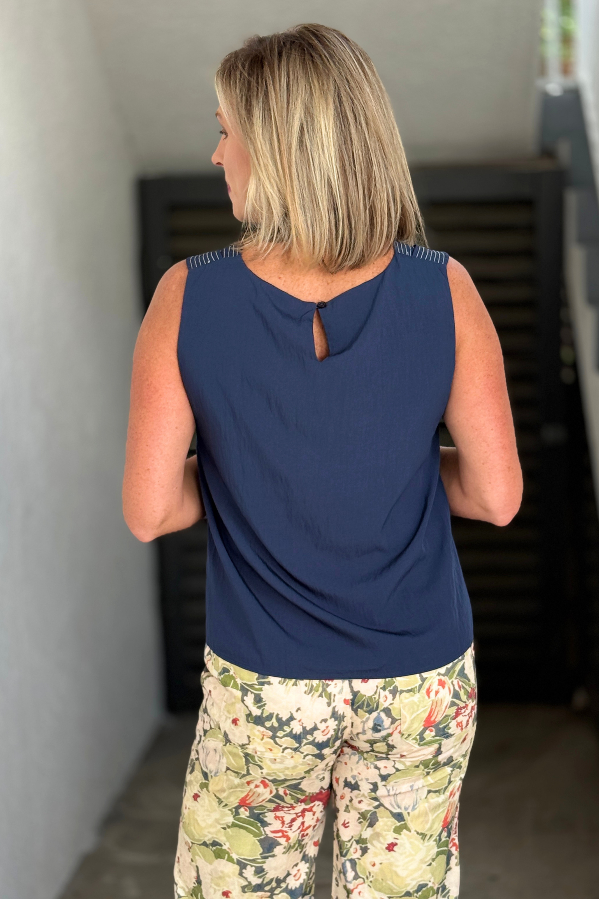 Back view of navy sleeveless top with keyhole closure