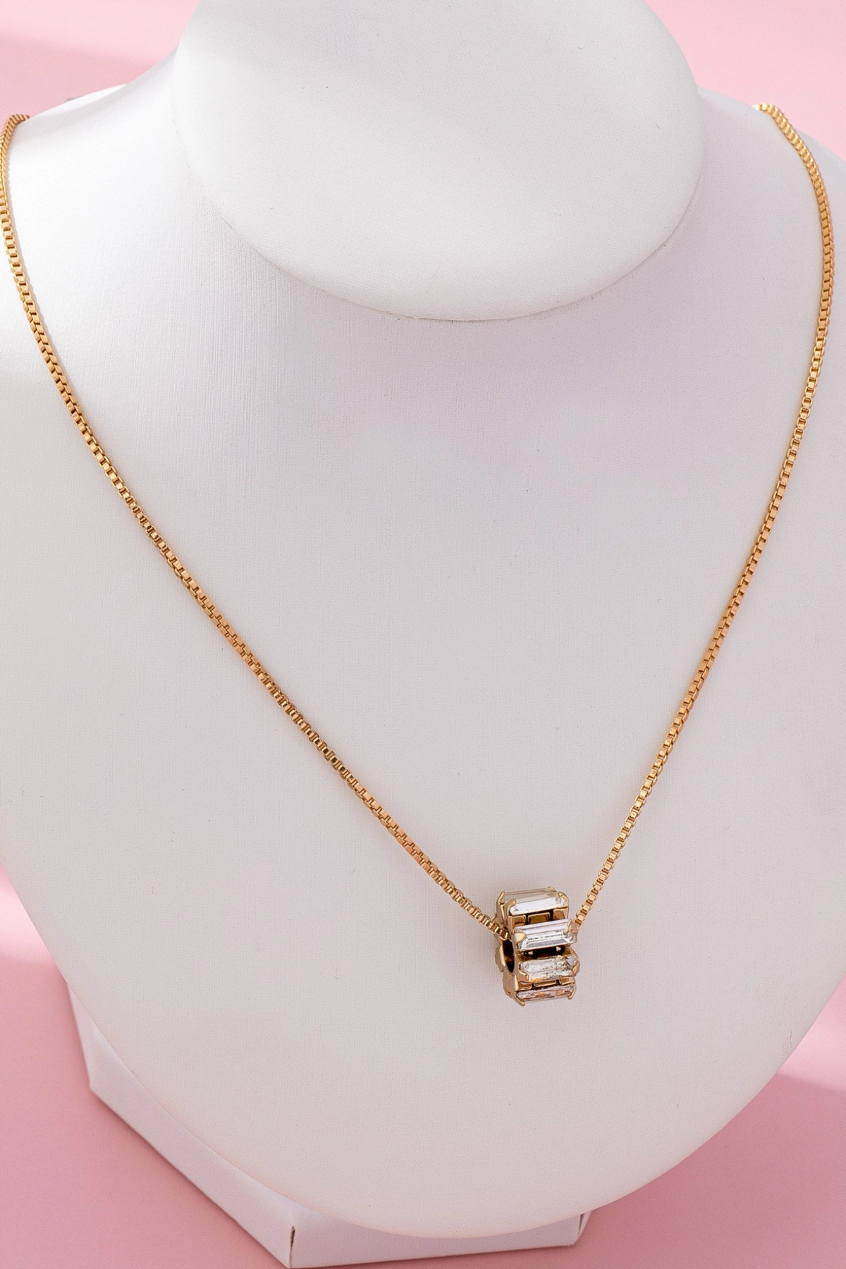 gold baguette barrel pendant necklace close up