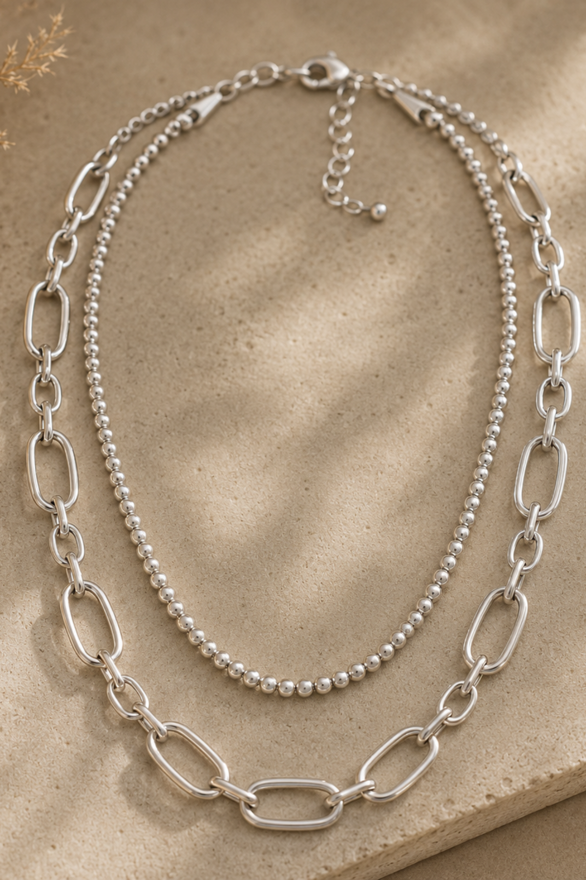 Layered silver beaded chain necklace.