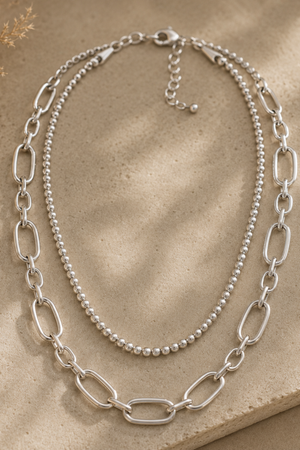 Layered silver beaded chain necklace.