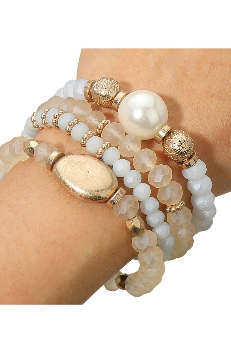 Neutral beaded stretch bracelet stack featuring gold and pearl details