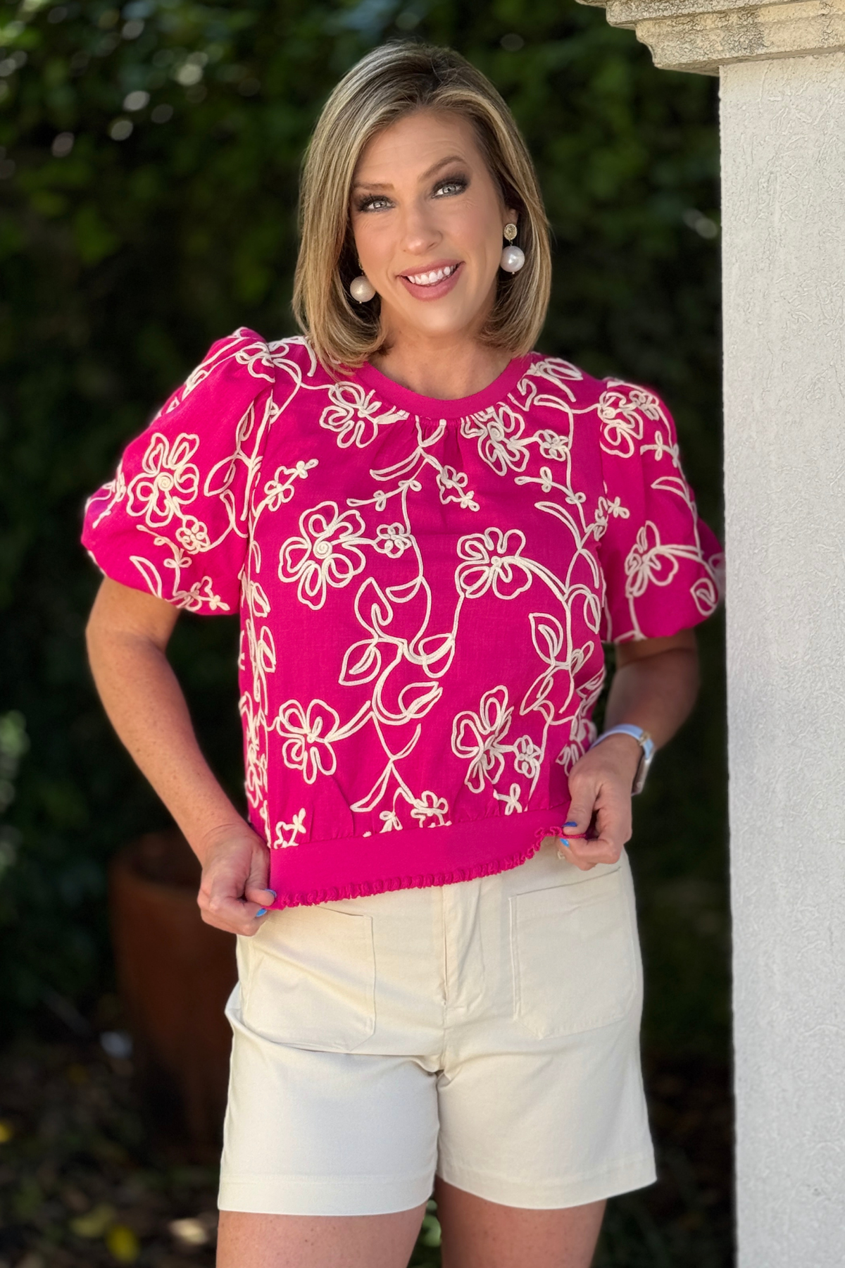 bright pink floral embroidered top styled with shorts