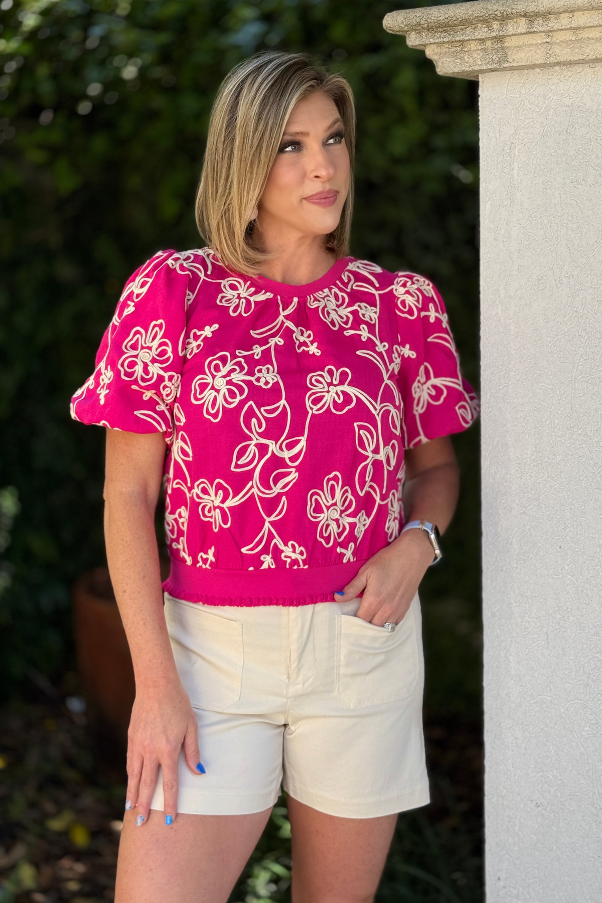 side view of pink embroidered blouse with bubble sleeves