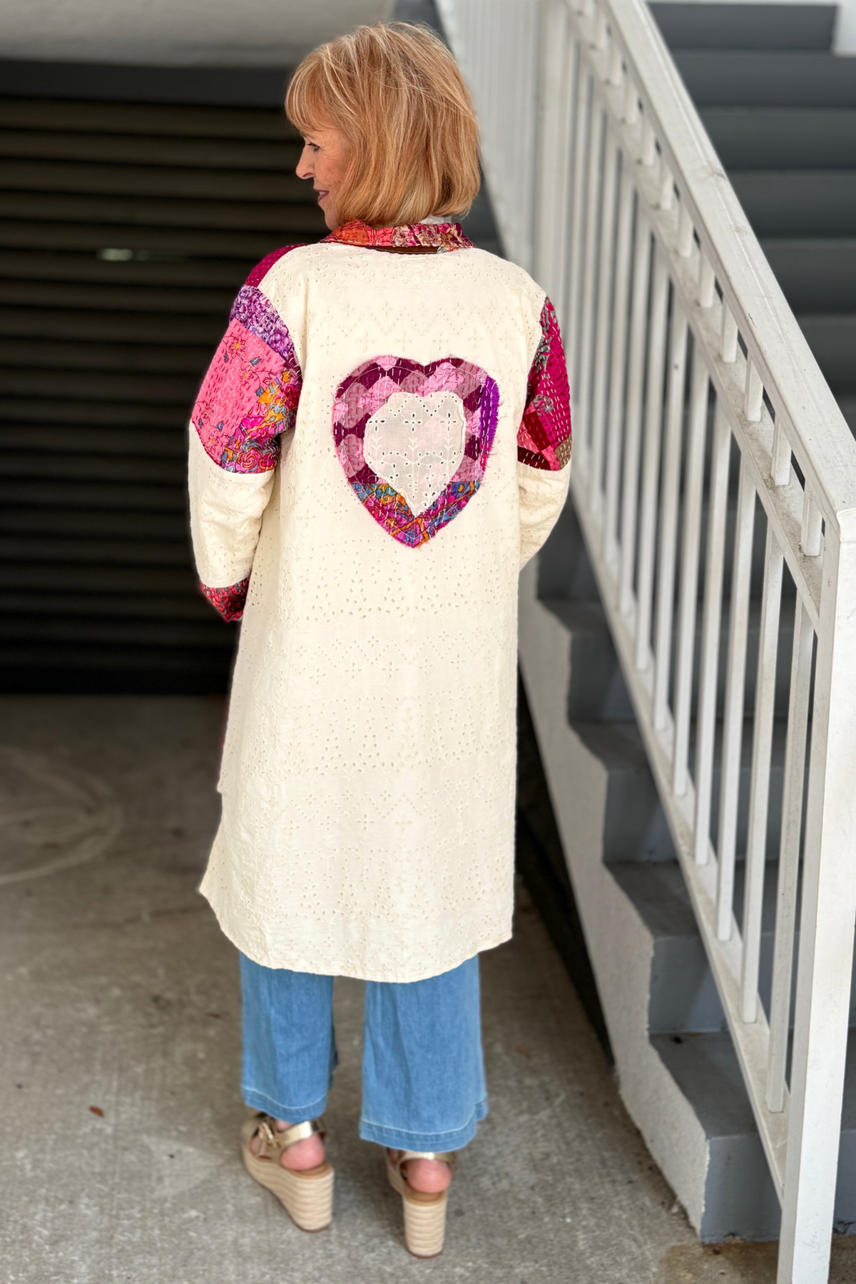 Back view of cream patchwork duster with oversized heart appliqué