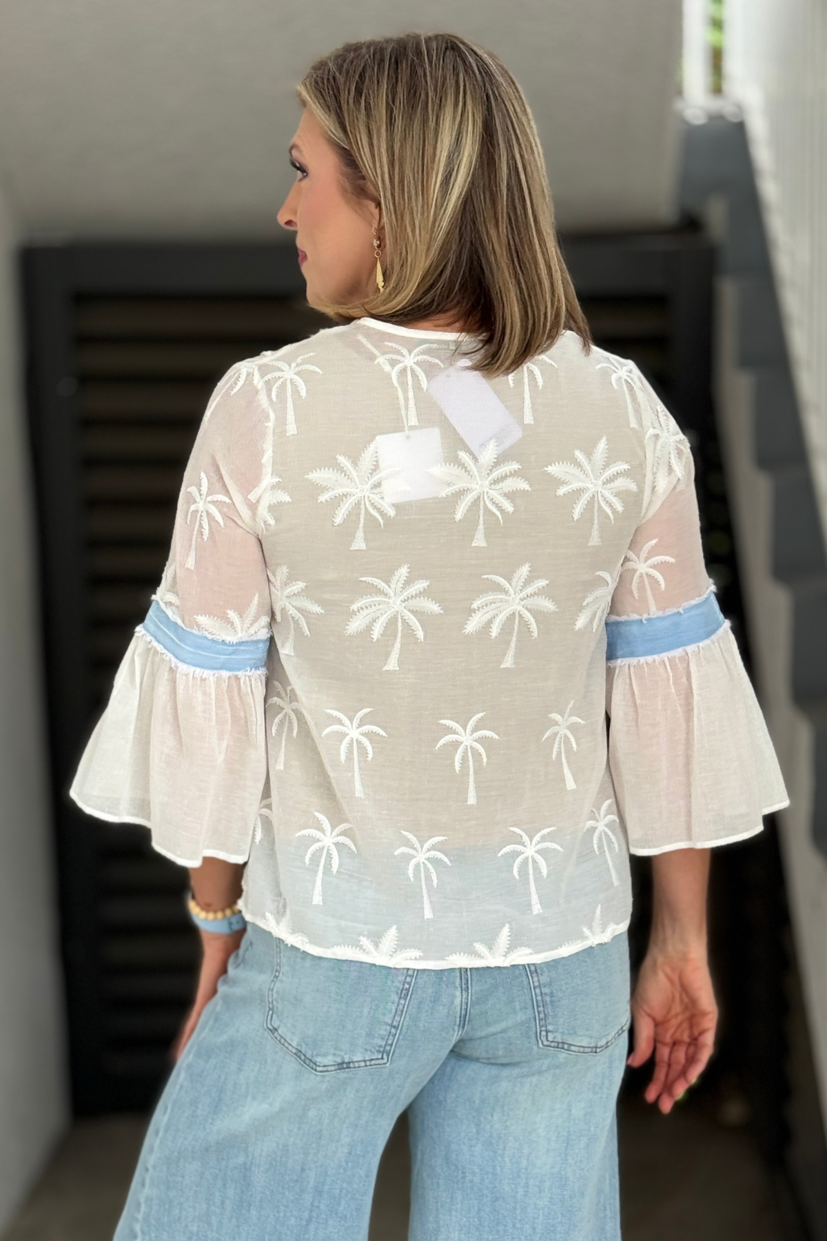 Lightweight tropical-inspired blouse styled with denim jeans