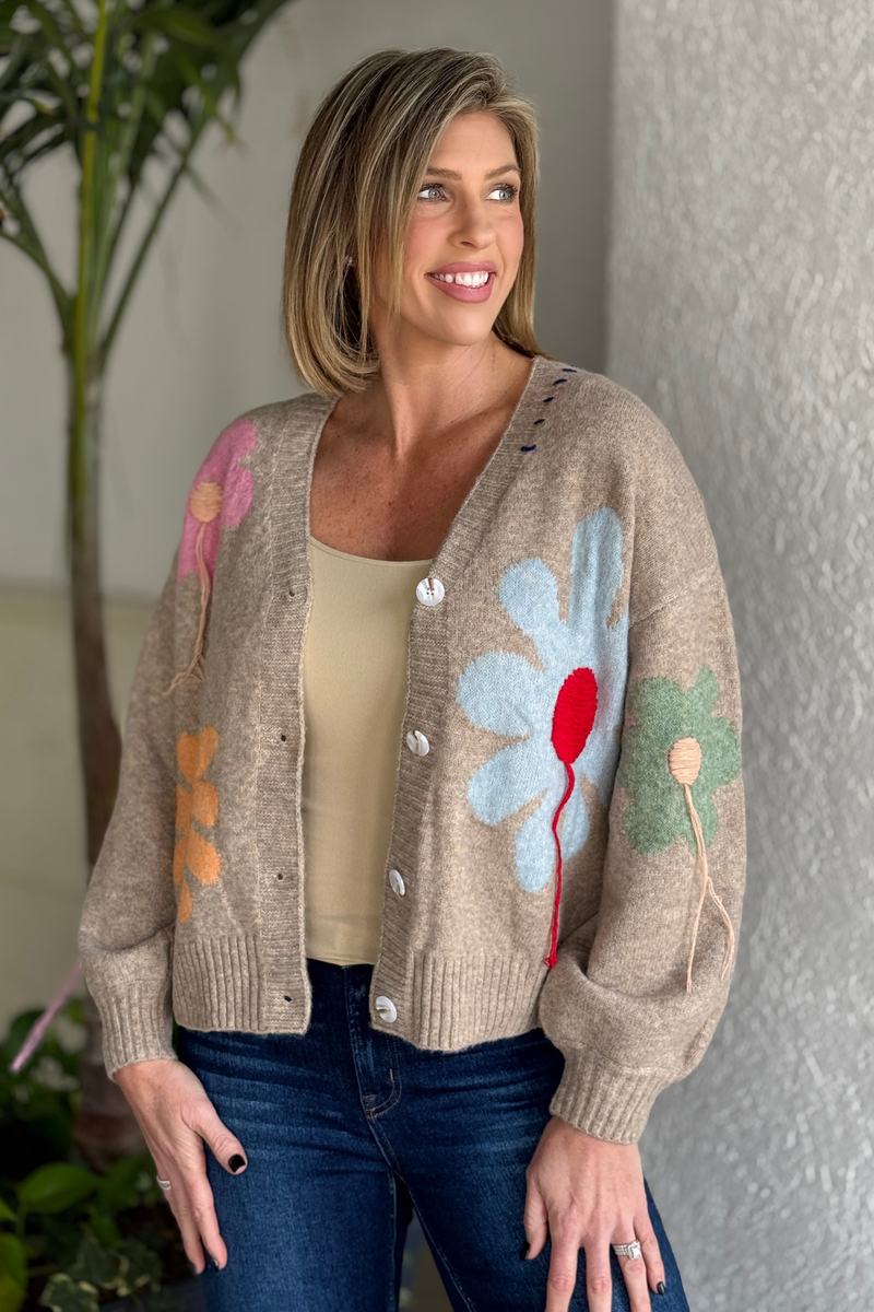 front view of button down floral applique cardigan with textured fringe details