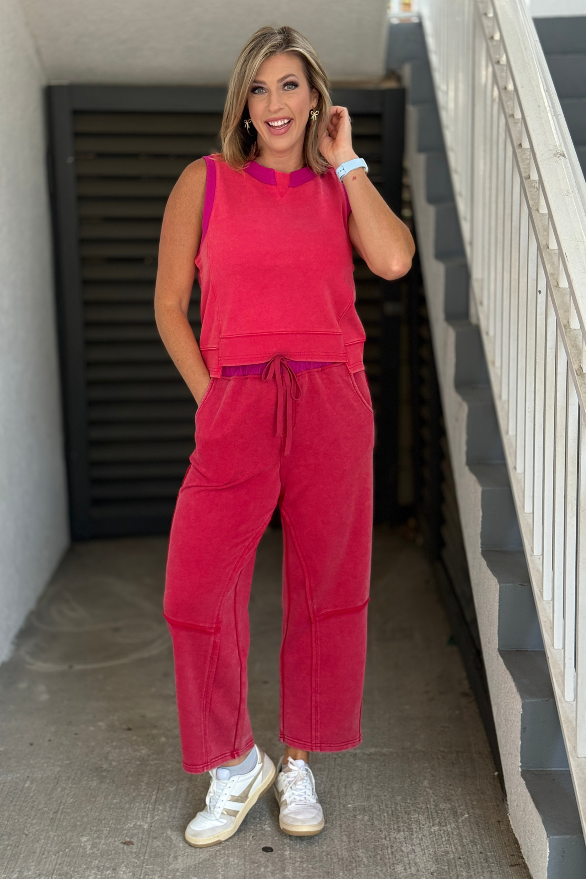 Woman wearing a pink French terry lounge set with sleeveless top and barrel leg pants