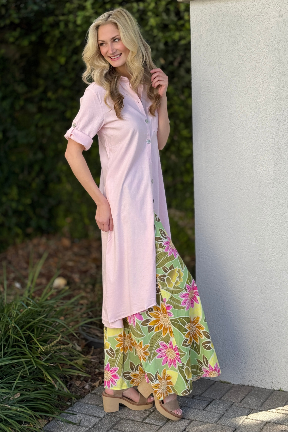 Side view of baby pink linen tunic showing rolled sleeve tab detail